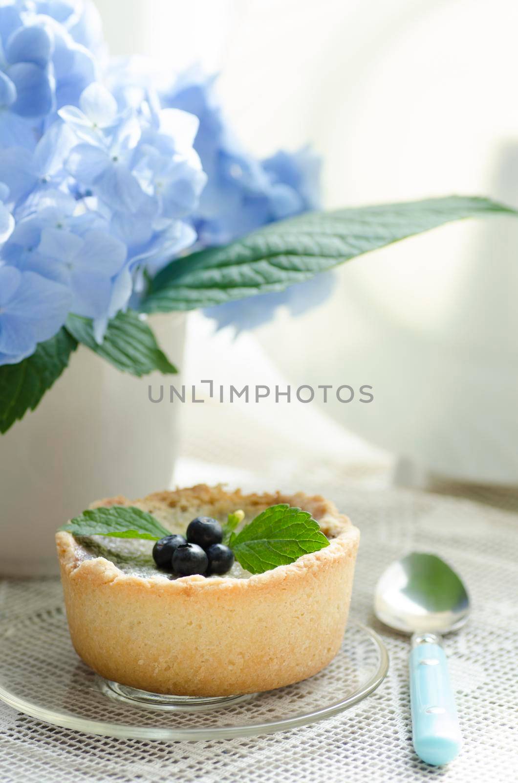 Mini berry tarts decorated with raspberries and blueberries