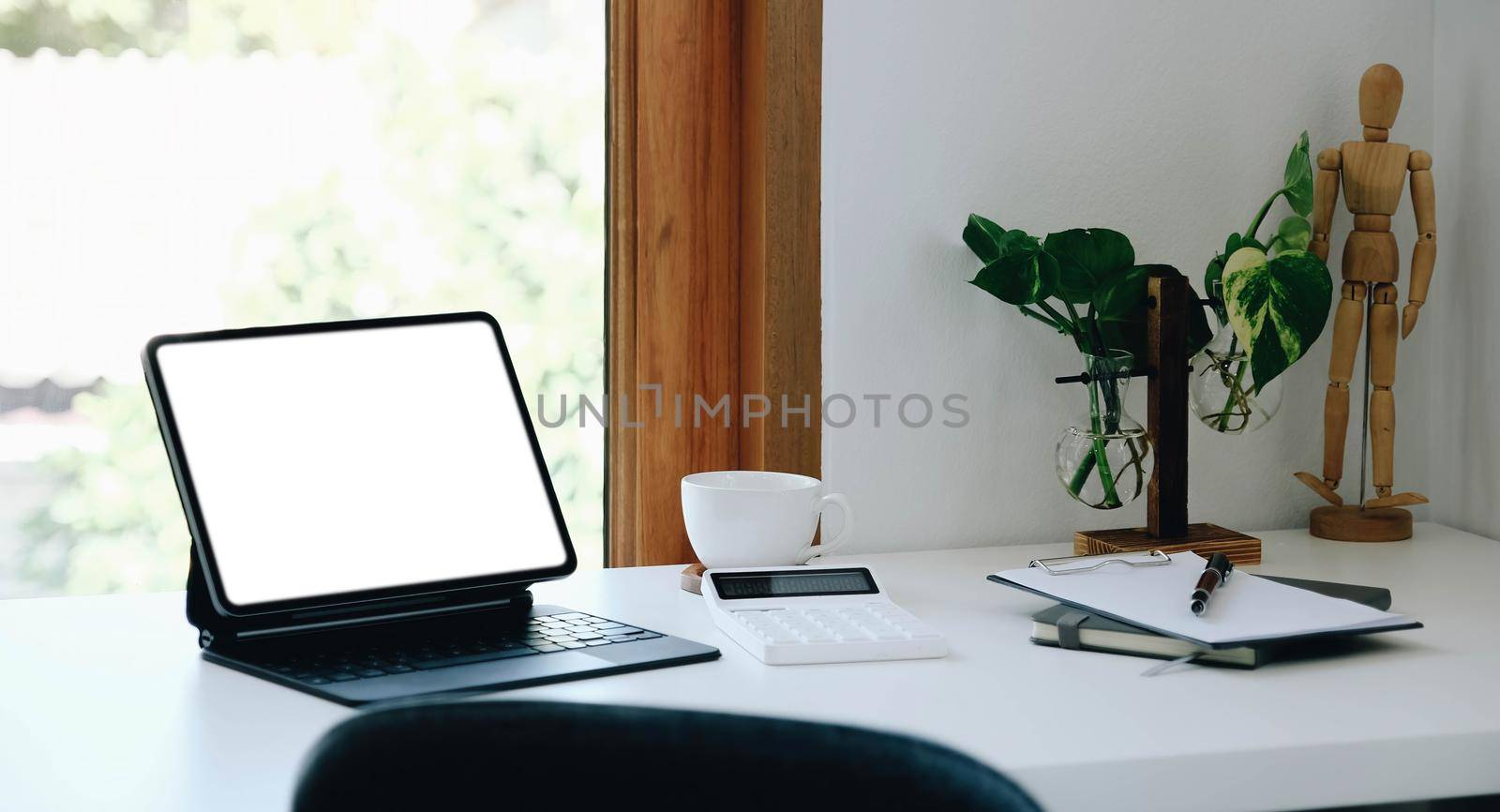 Digital tablet with white blank screen on table. workspace in modern office concept...