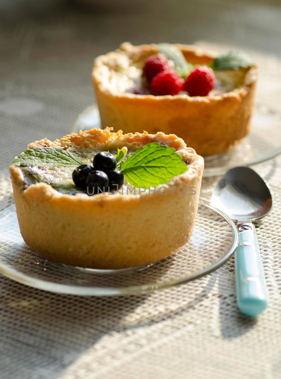 Mini berry tarts decorated with raspberries and blueberries