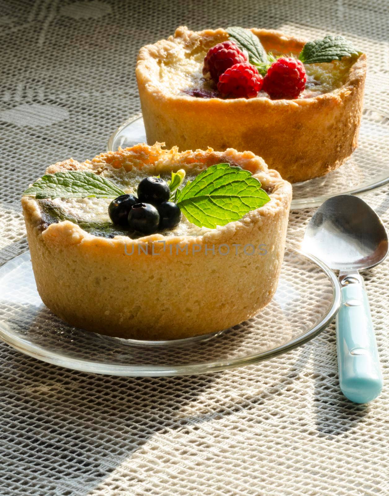 Mini berry tarts decorated with raspberries and blueberries