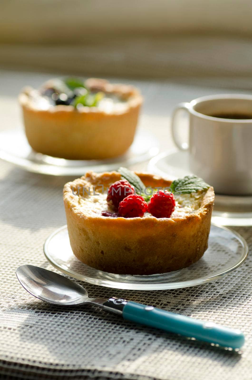 Mini berry tarts decorated with raspberries and blueberries