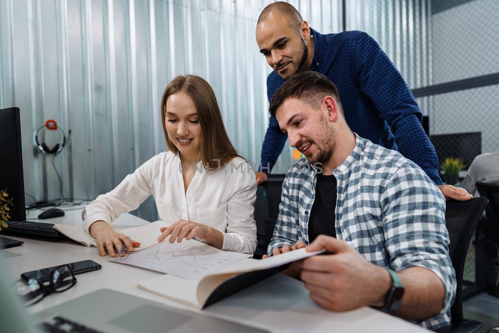 Group of young business people working in office by Fabrikasimf