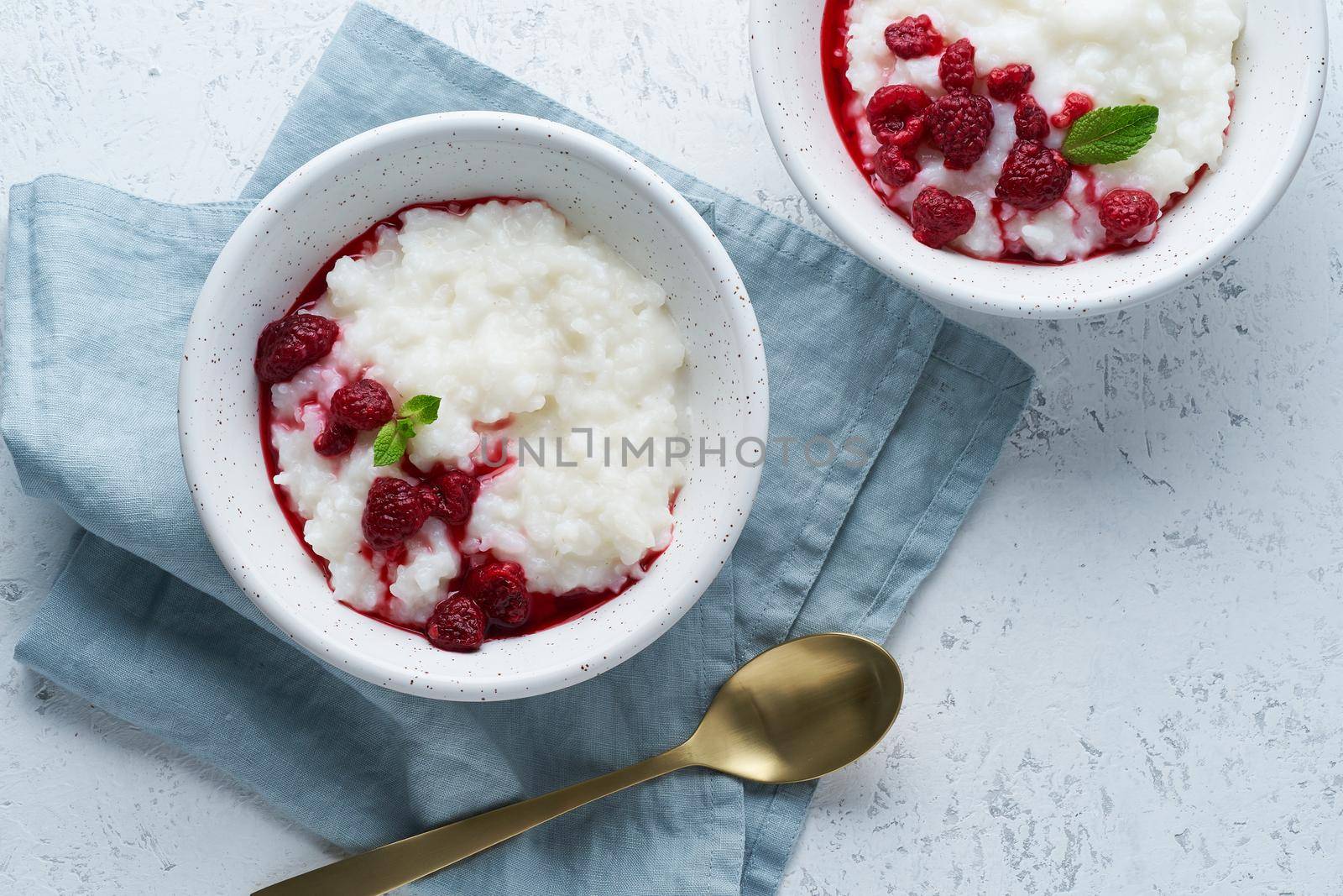 Vegan Coconut Rice Pudding. Vegan diet breakfast with a coconut milk, raspberry, scandinavian minimalism, top view, copy space