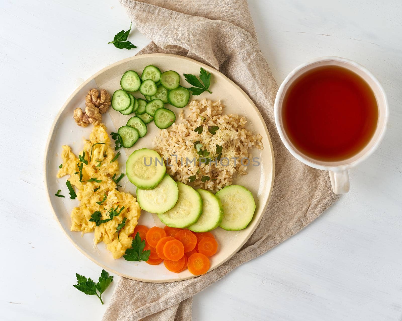 clean eating brown rice with zucchini and scramble with carrot and parsley, top view closeup