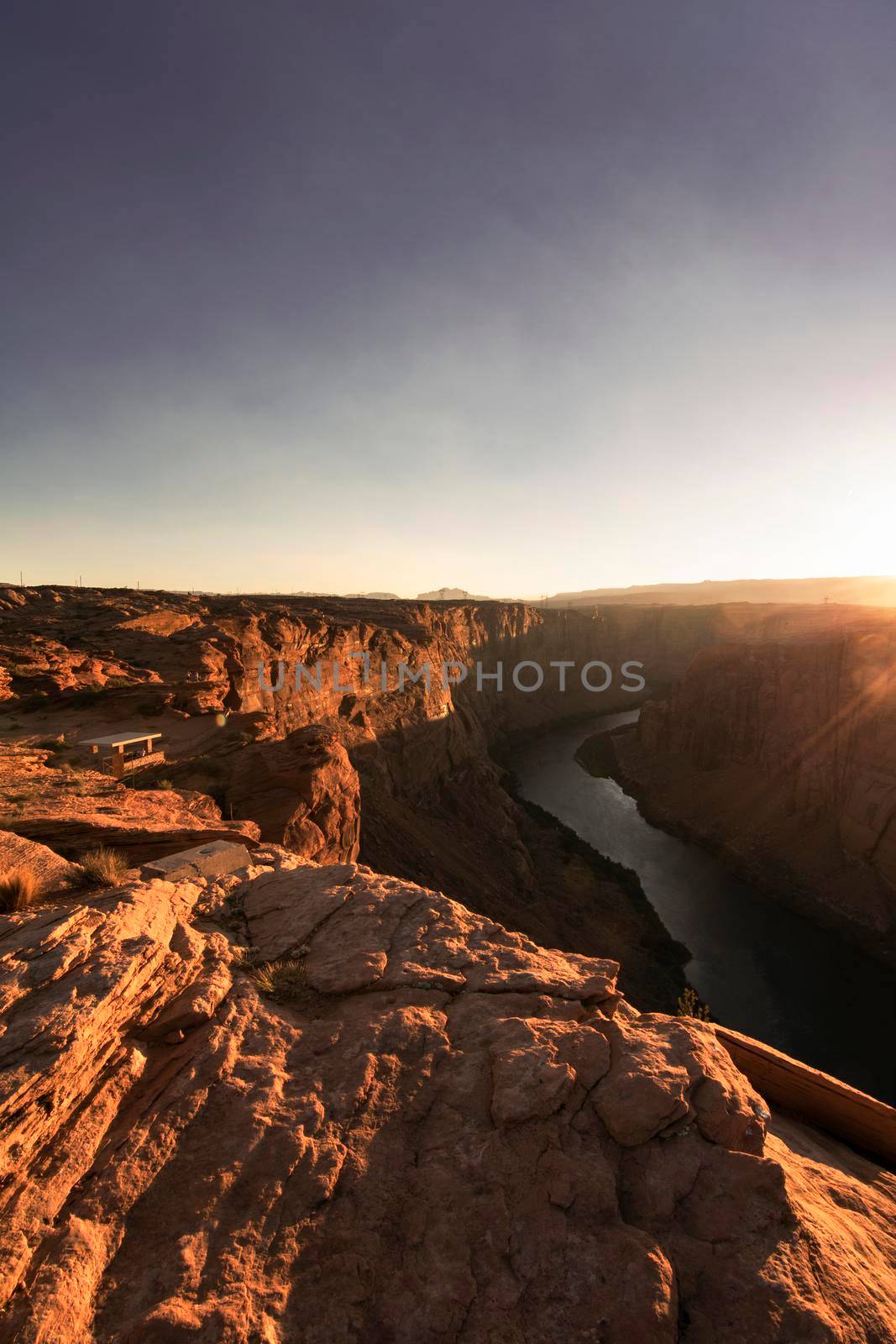Golden hour view of Colorado river crossing a canyon in Page in Arizona USA