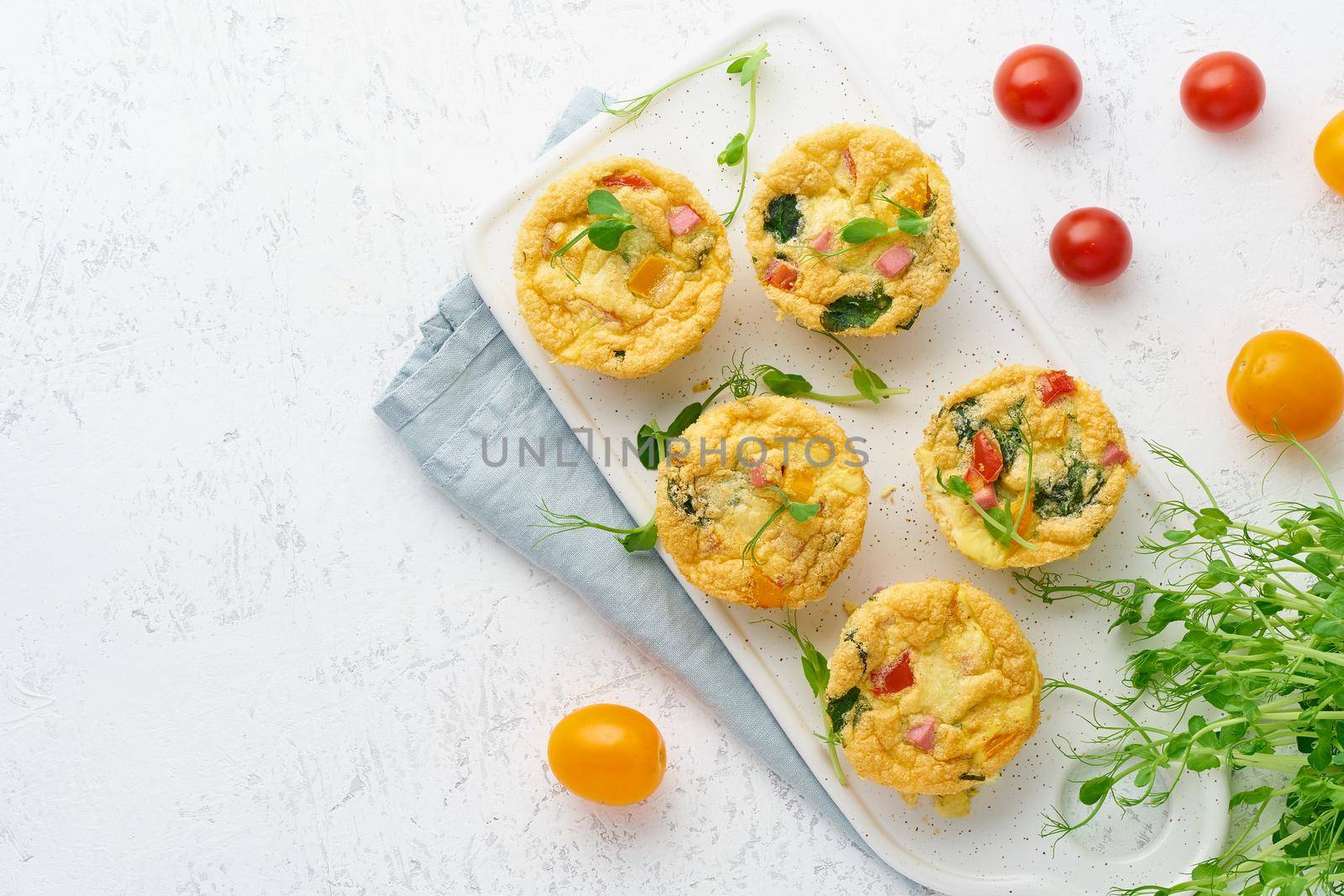 omelet with tomatoes and bacon, baked eggs with spinach and broccoli, top view with copy space, keto, ketogenic diet