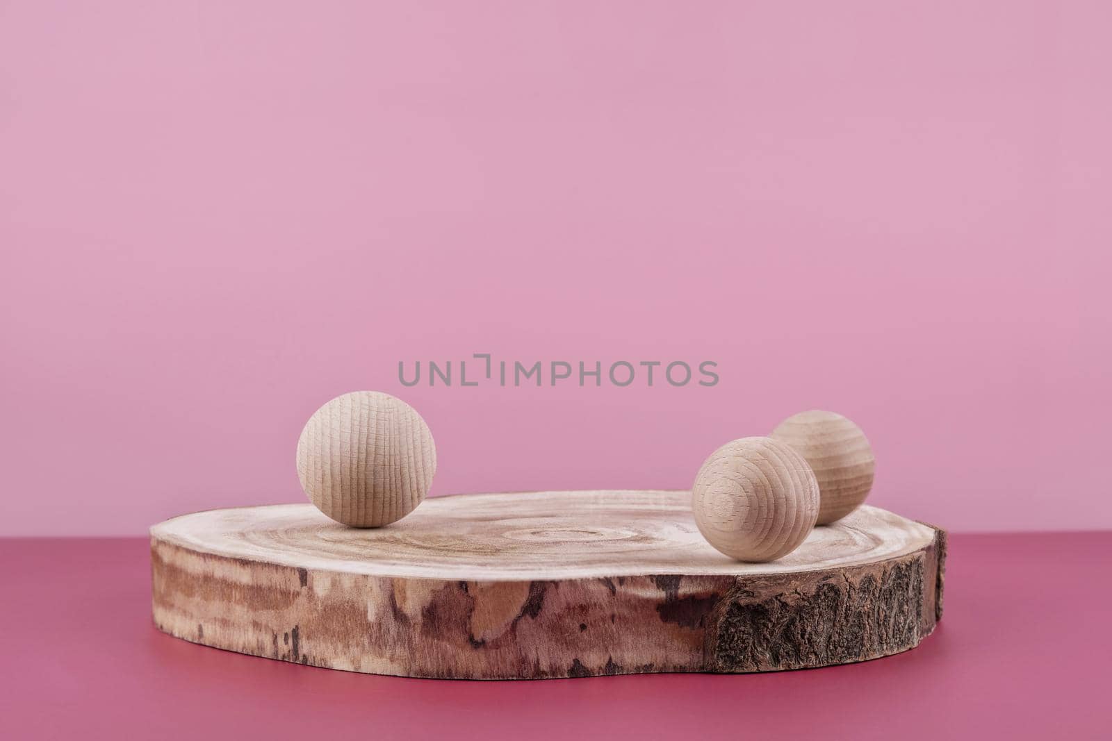 Background for cosmetic product presentation, wooden podium showcase on pink backdrop for cosmetics perfume and jewellery display with stylish props. Empty stage pedestal for beauty products