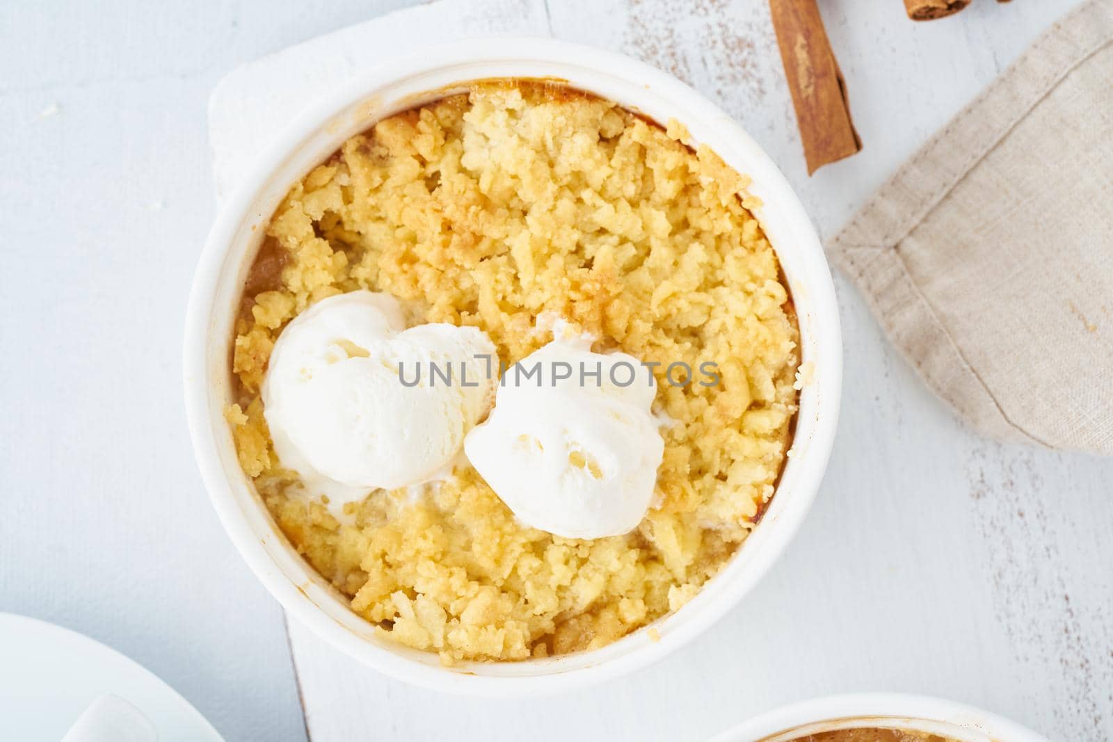 Apple crumble with ice cream, streusel. Morning breakfast on light gray table. Top view, close up