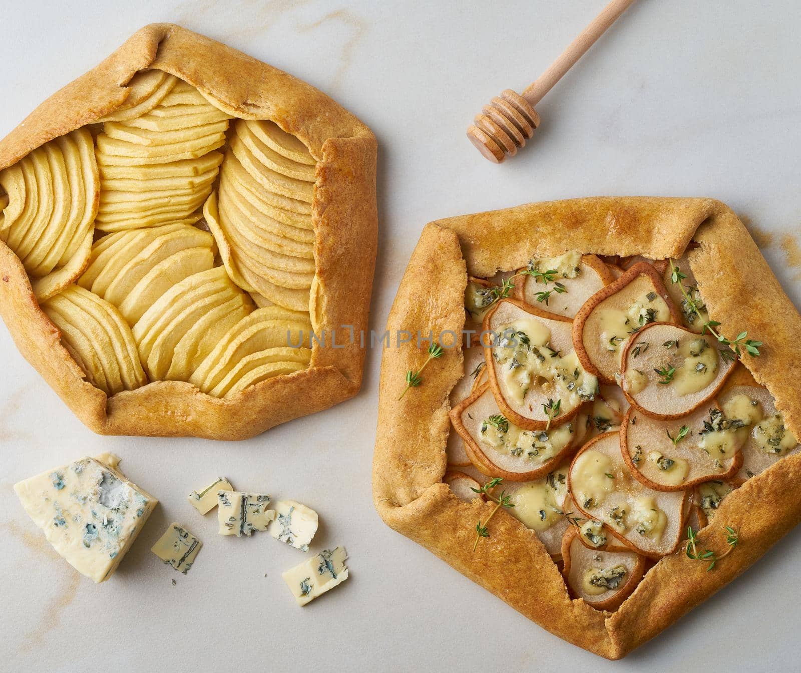 Fruit galette, apple pie with a honey, savory pear and cheese pie, marble table, top view