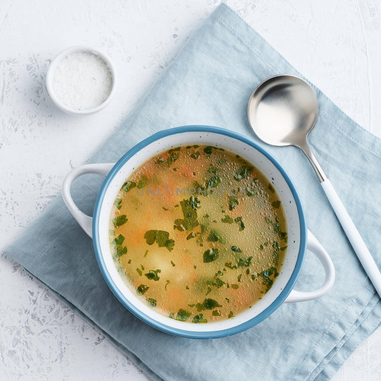 chicken soup, scandinavian homemade food with on blue stone table, top view by NataBene