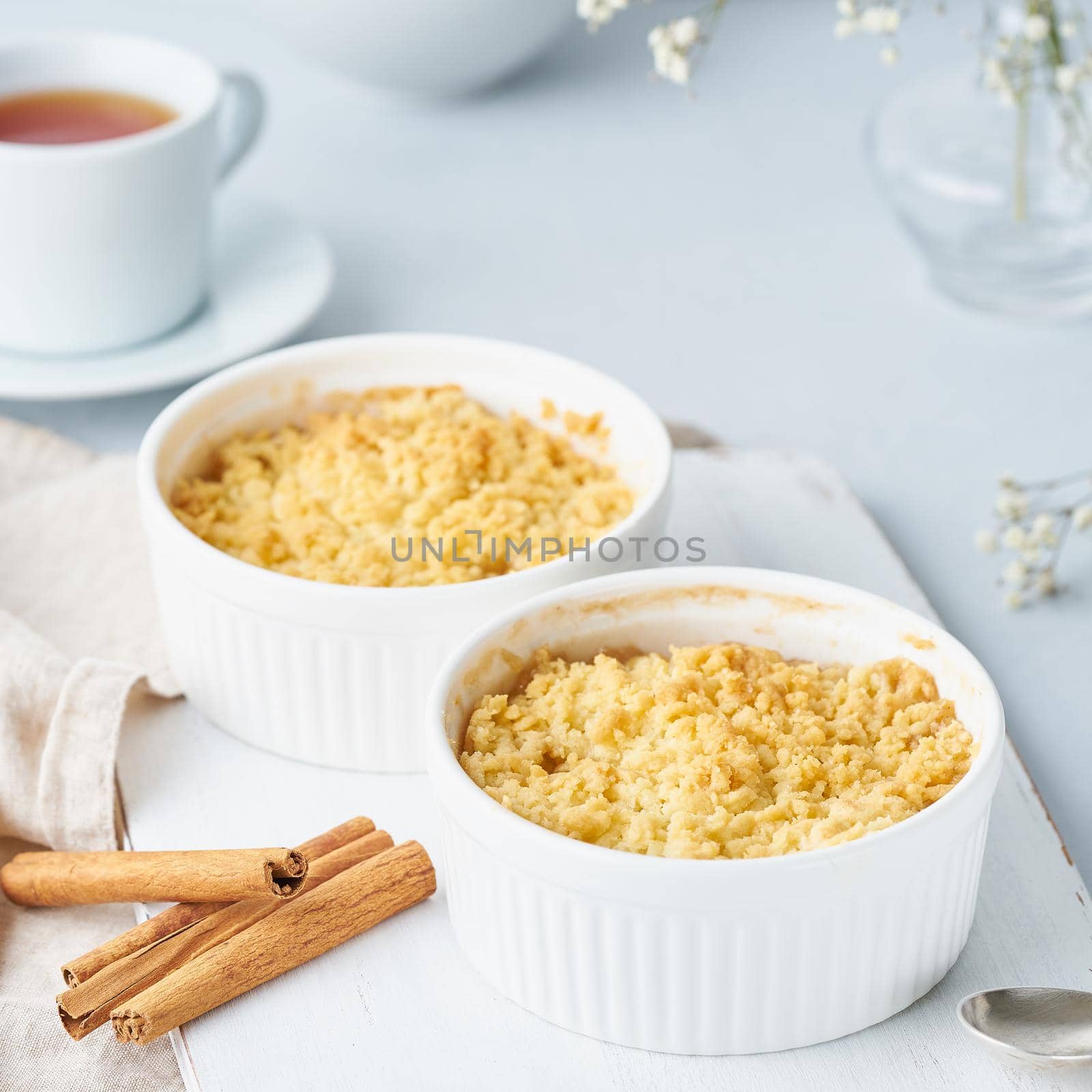 Close up apple crumble with streusel. Side view, close up. Morning breakfast on light gray table.