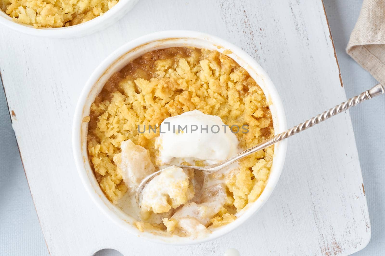 Apple crumble with ice cream, streusel. Morning breakfast on light gray table. Top view, close up