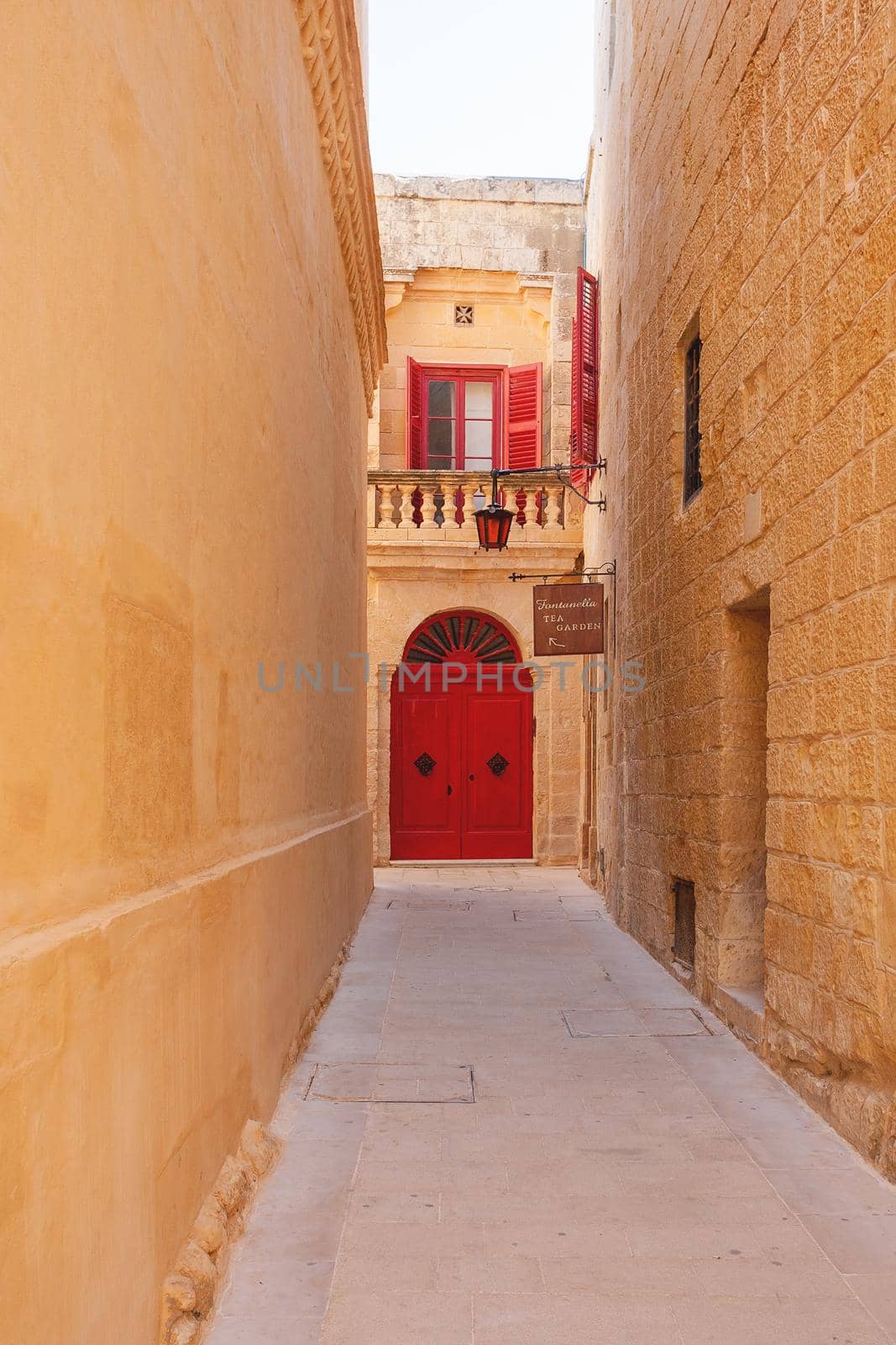 MDINA, MALTA - February 18, 2010. Narrow streets of Mdina, old capital of Malta. Stone buildings with old fashioned doors and balconies. by aksenovko