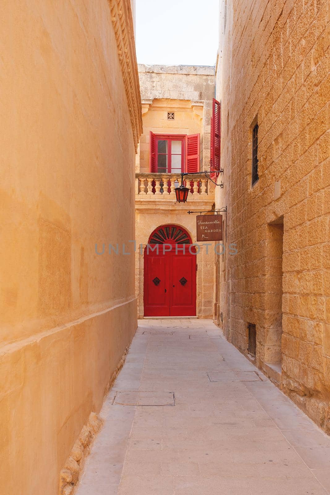 MDINA, MALTA - February 18, 2010. Narrow streets of Mdina, old capital of Malta. Stone buildings with old fashioned doors and balconies.