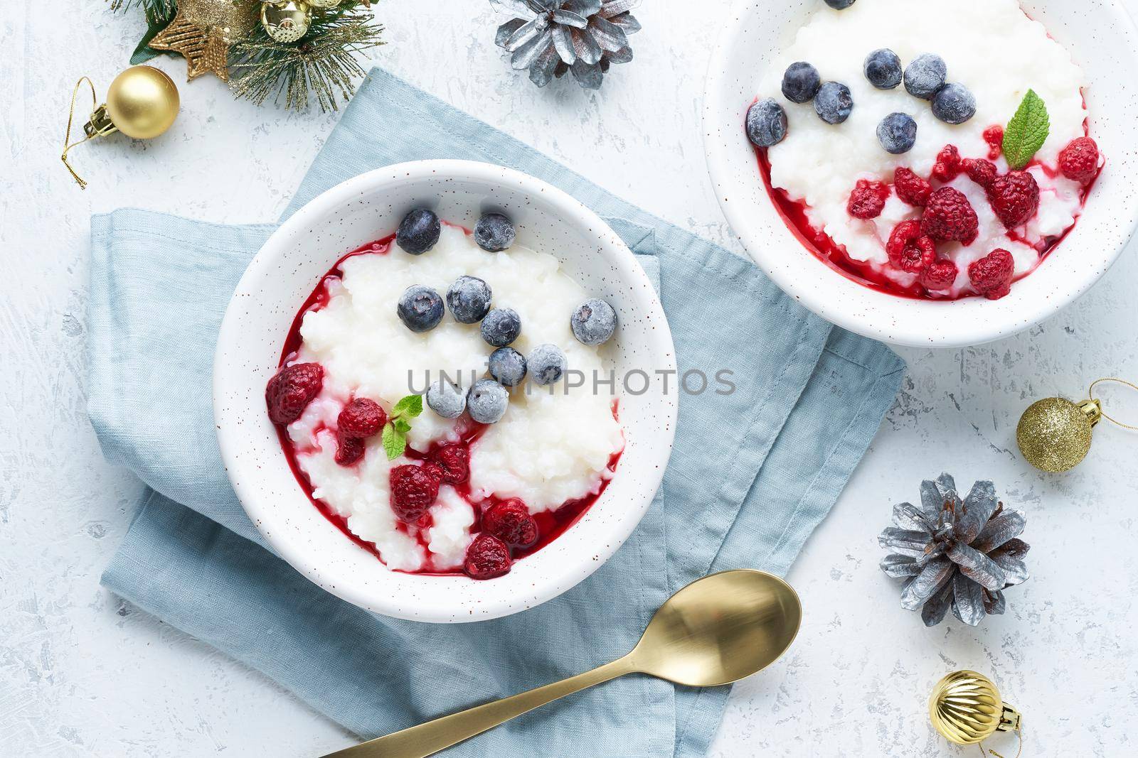 Christmas food, rice pudding, top view. Healthy Vegan diet breakfast with coconut milk, a berries, scandinavian minimalism