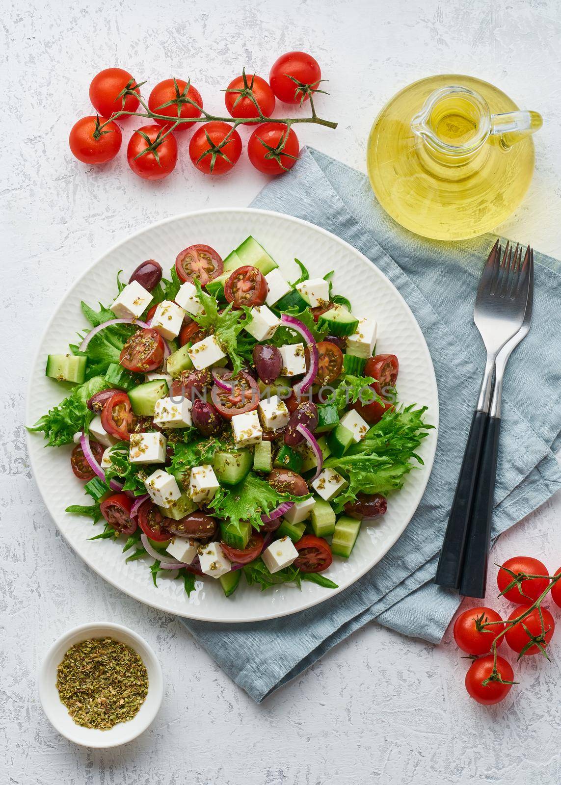 Greek Salad with feta and tomatoes, dieting food on white background vertical top view by NataBene