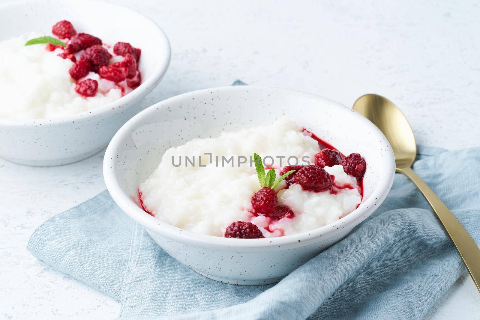 Rice pudding, side view. Healthy Vegan diet breakfast with a coconut milk, raspberry, scandinavian minimalism