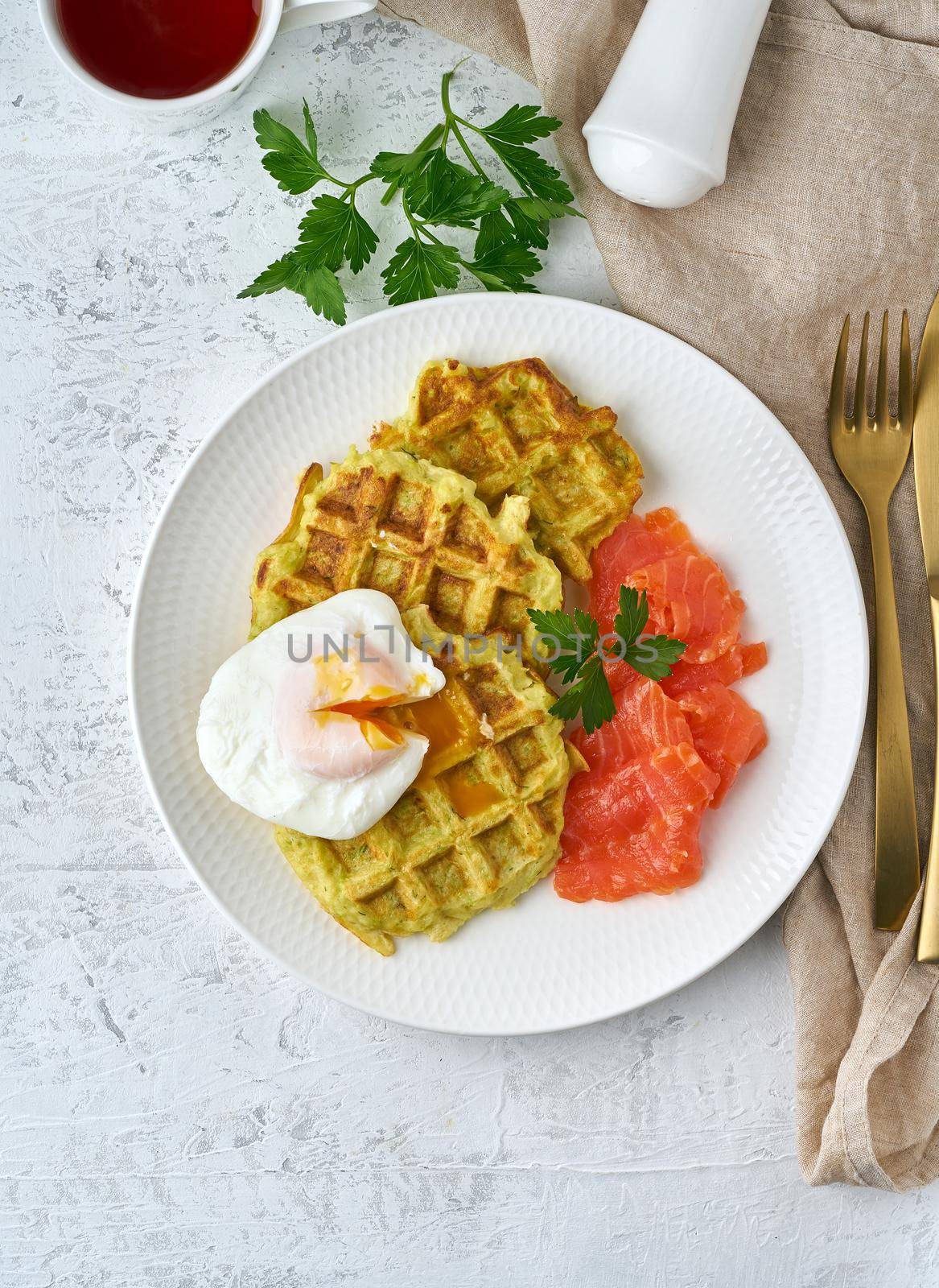 Zucchini waffles with salmon and benedict egg, fodmap diet top view by NataBene