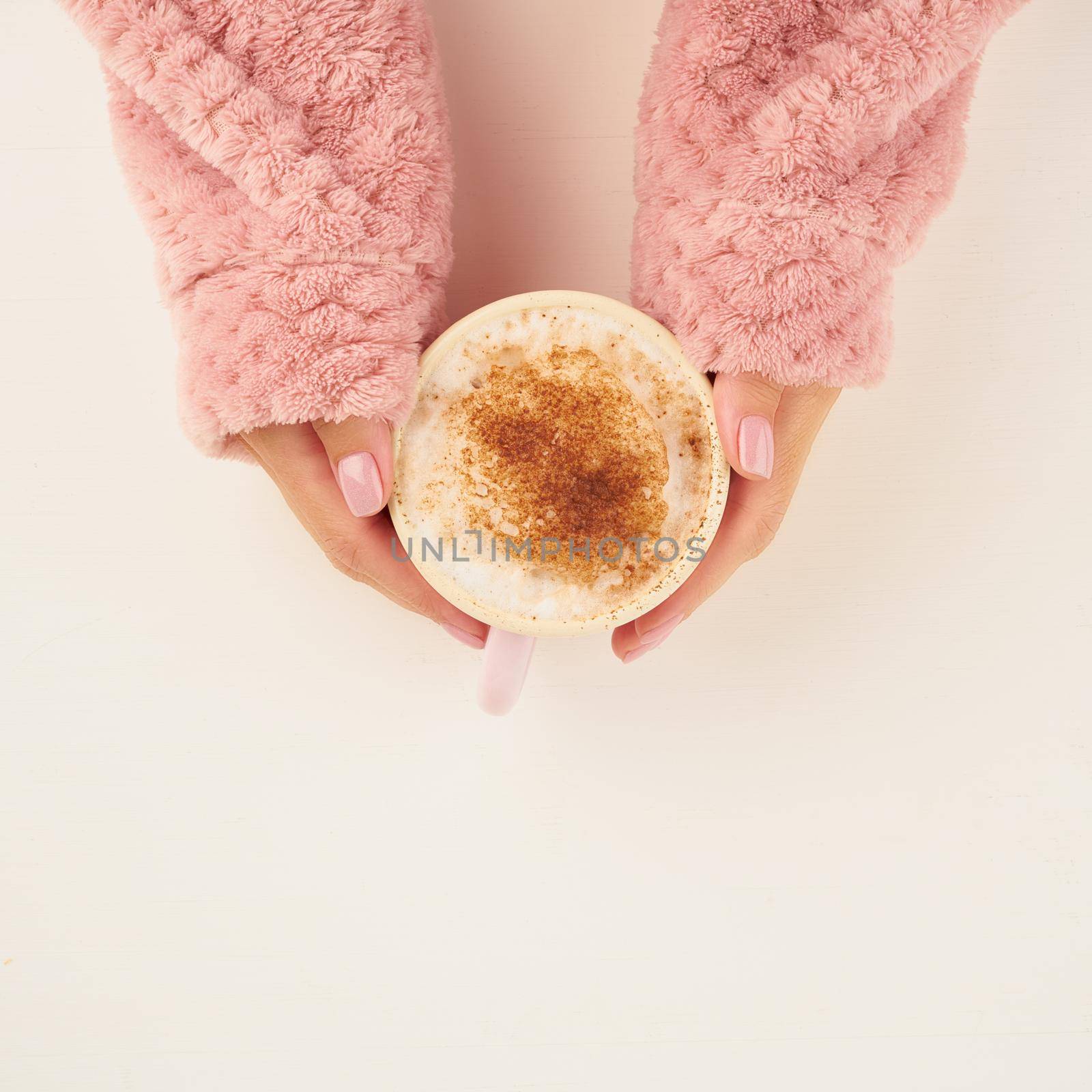 morning hot coffee on cold autumn morning, hands holding mug with a drink, cozy atmosphere, top view, copy space by NataBene