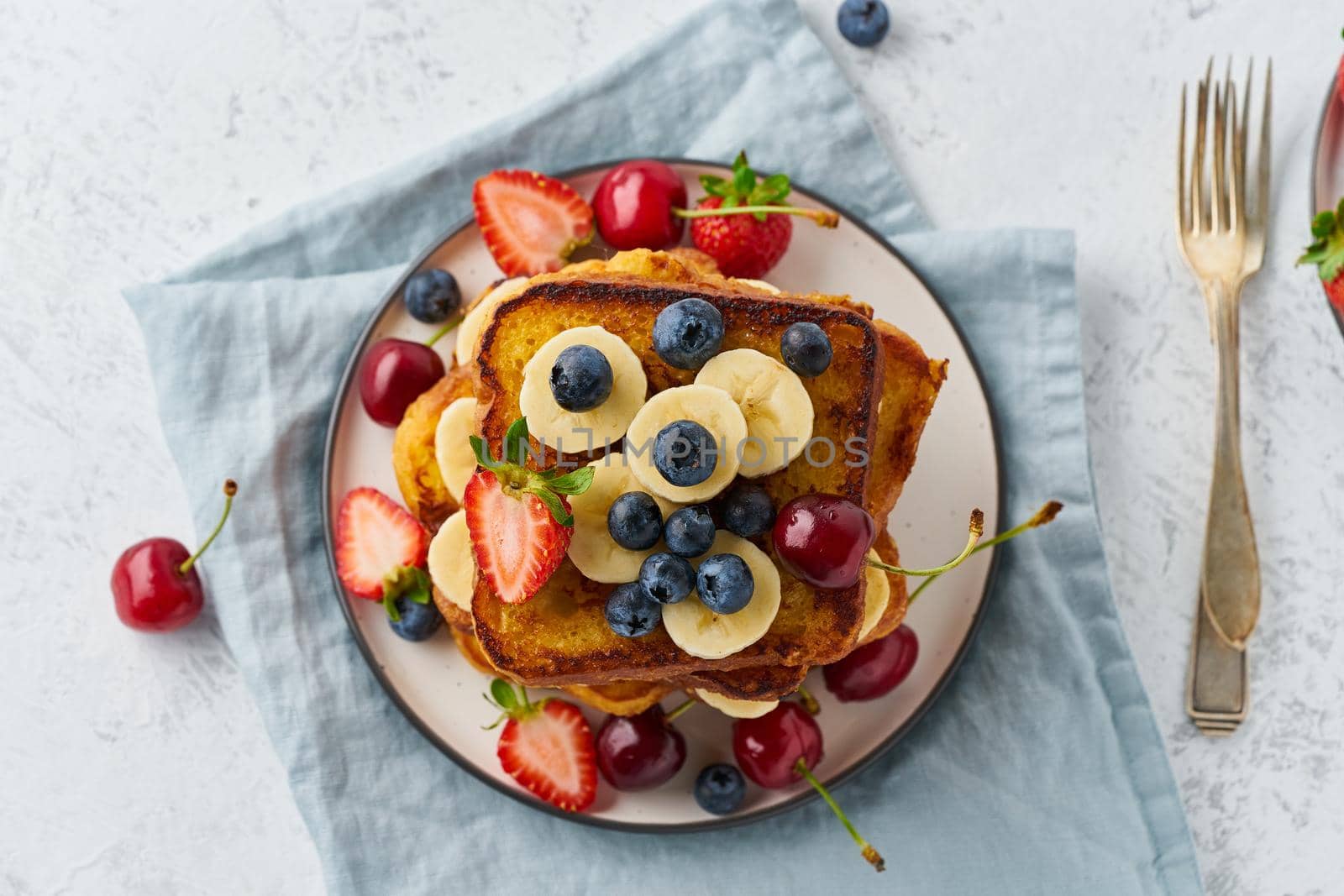 healthy french toasts with berries and banana, confort stack of toasts, homemade brioche