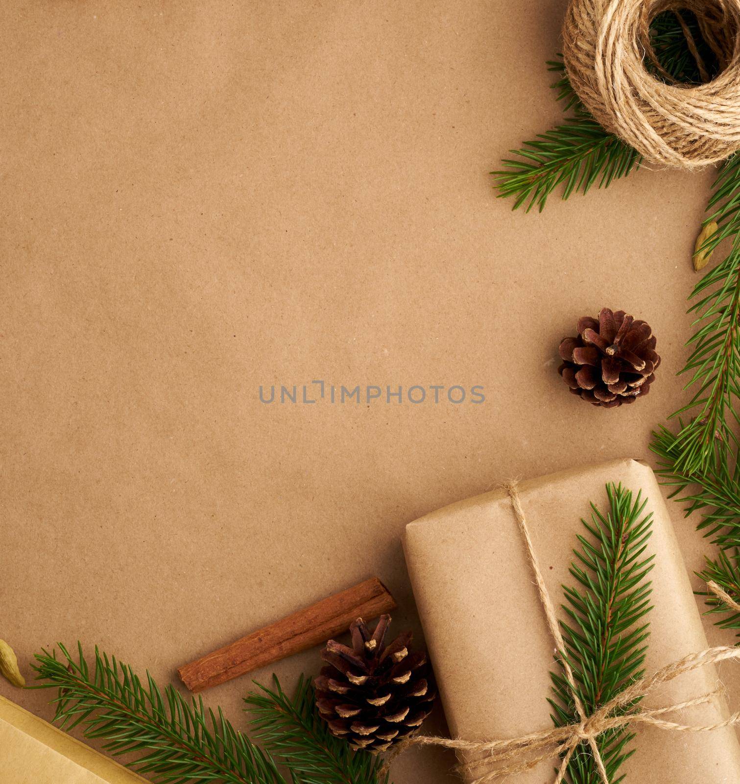 Christmas and Happy New Year zero waste craft paper background. Handmade gift Christmas box, fir branches, close up, top view, copy space. Hand crafted, plastic free concept by NataBene
