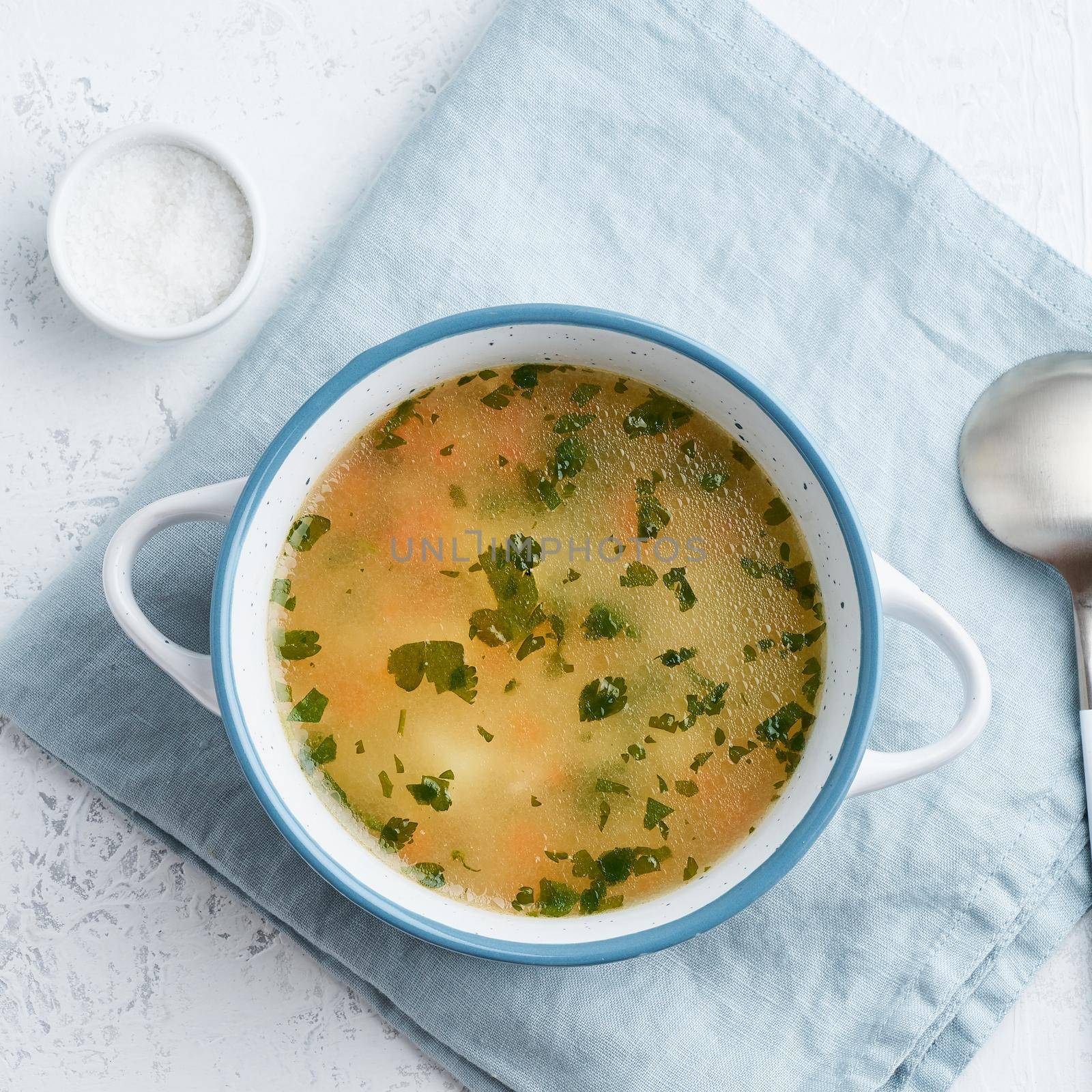 chicken soup, scandinavian homemade food with on blue stone table, top view by NataBene