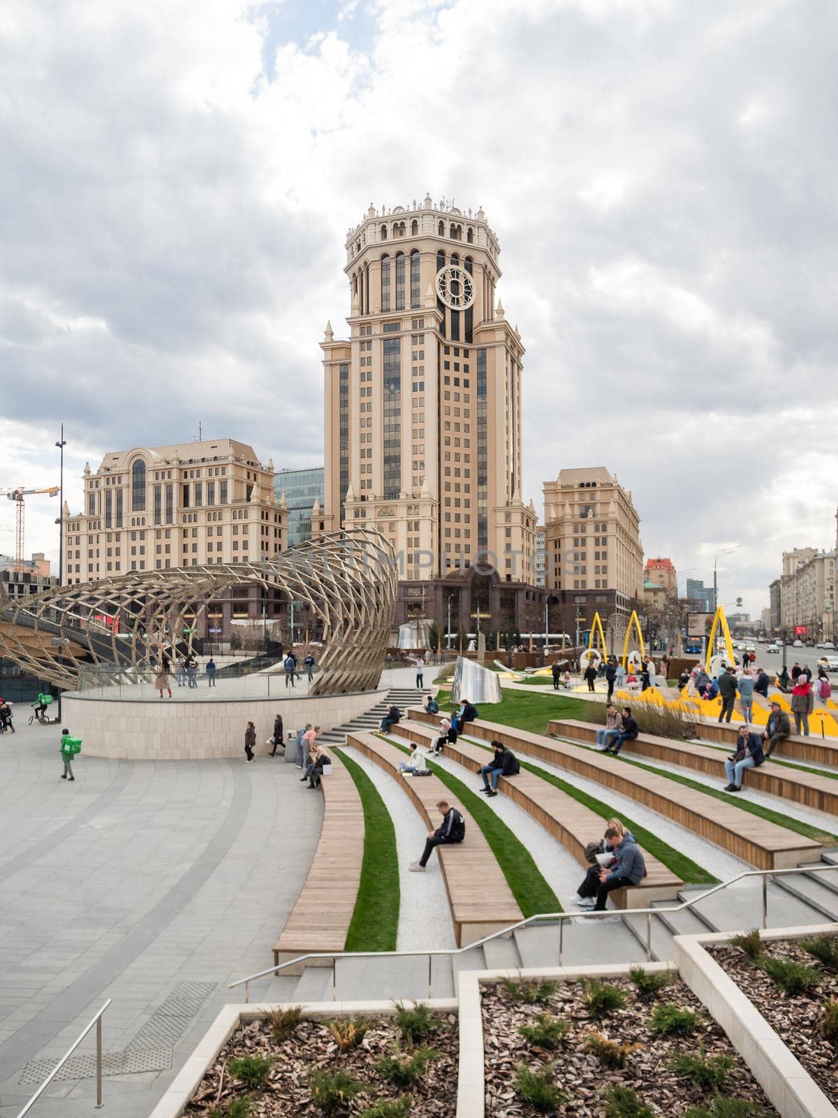 MOSCOW, RUSSIA - May 01, 2022. Local people and tourists walk on square near Paveletsky railway. Modern urban architecture. by aksenovko