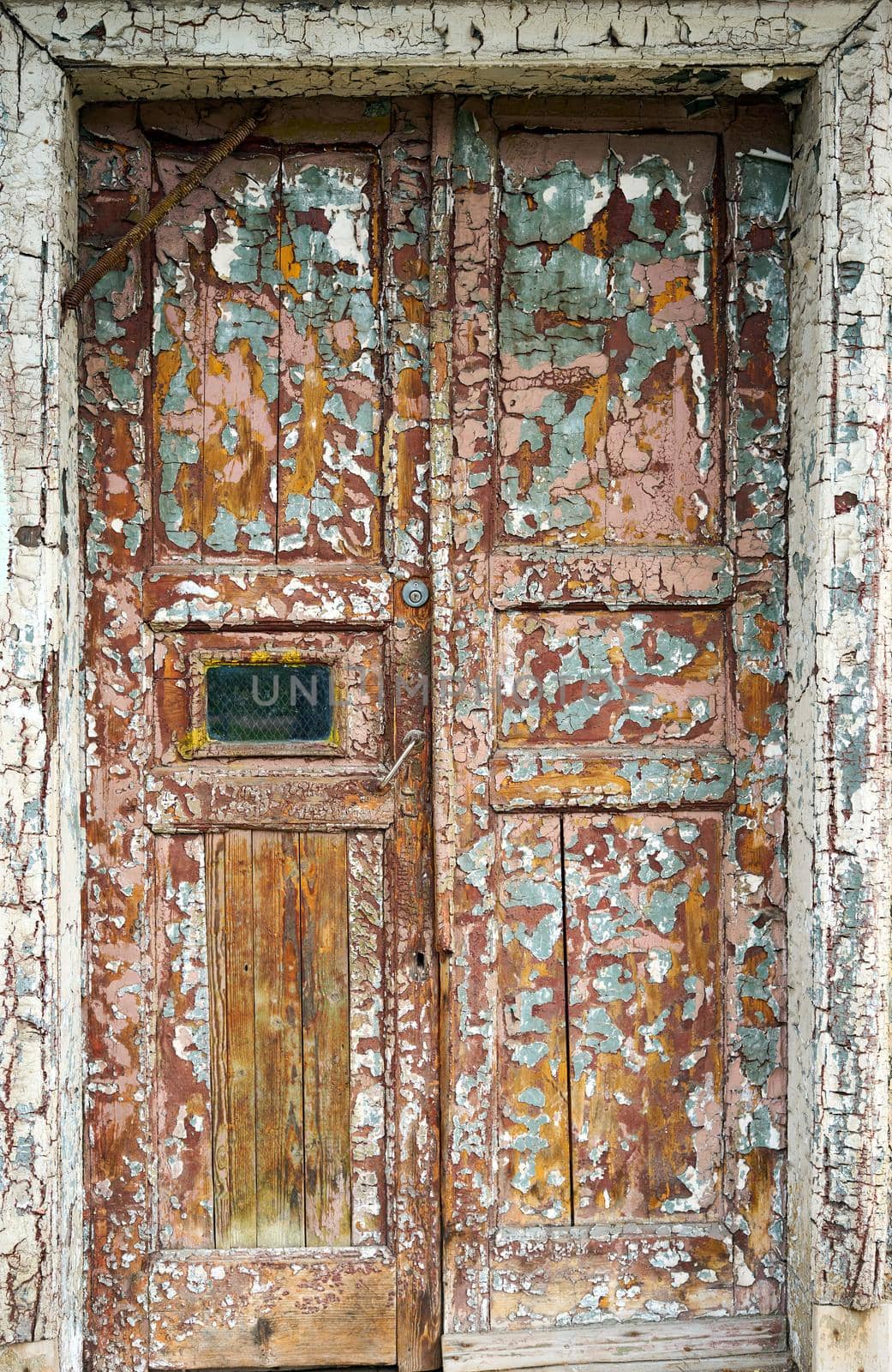 old cracked brown door on the front of the house, vertical