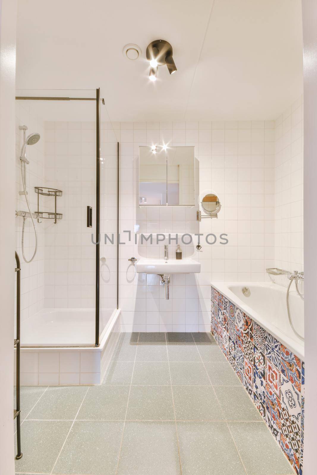Bathroom interior with tile mosaic, bathtub, sink and shower in a modern apartment