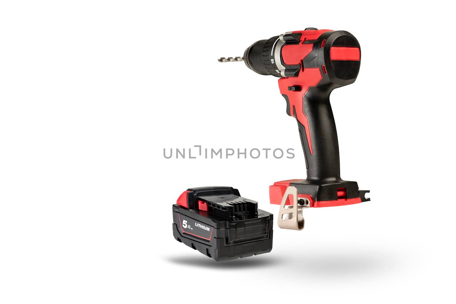 cordless tool isolated on white background. Cordless screwdriver with a drill inserted into the chuck and an extra battery on a white background. by SERSOL