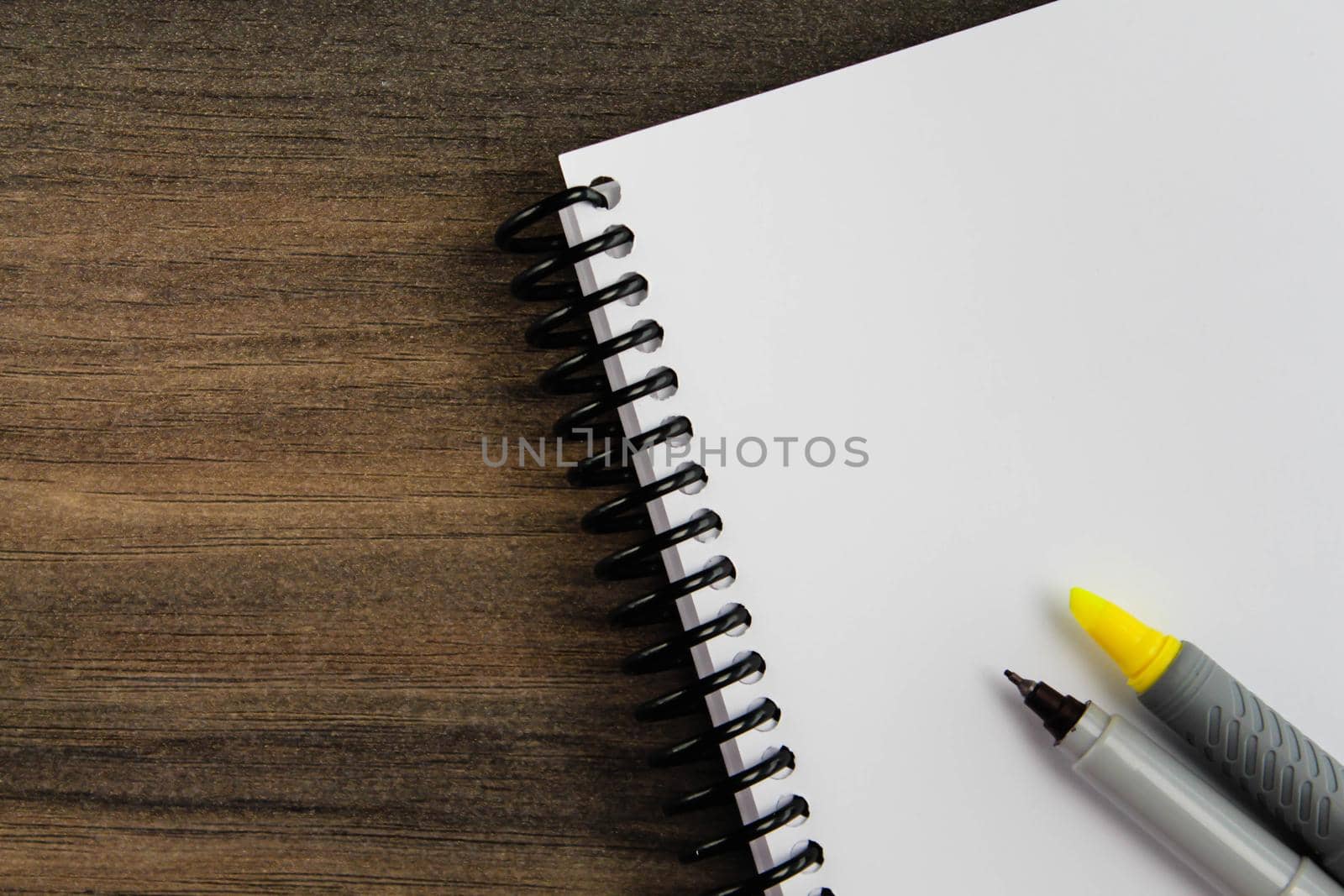 Spiral notebook, pen and paper on wooden background, top view with copy space by JuliaDorian