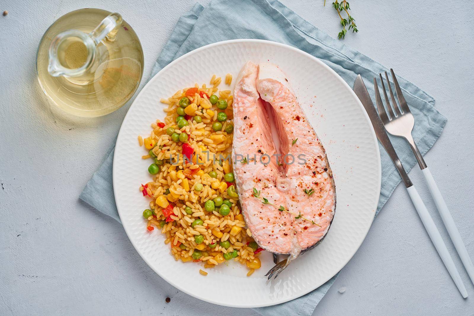 Paleo, keto, fodmap diet. Steam salmon and vegetables, white plate on a blue table, top view