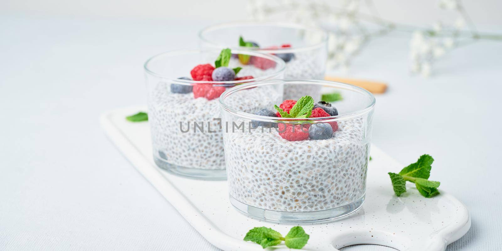 Banner with chia pudding with fresh berries raspberries, blueberries by NataBene