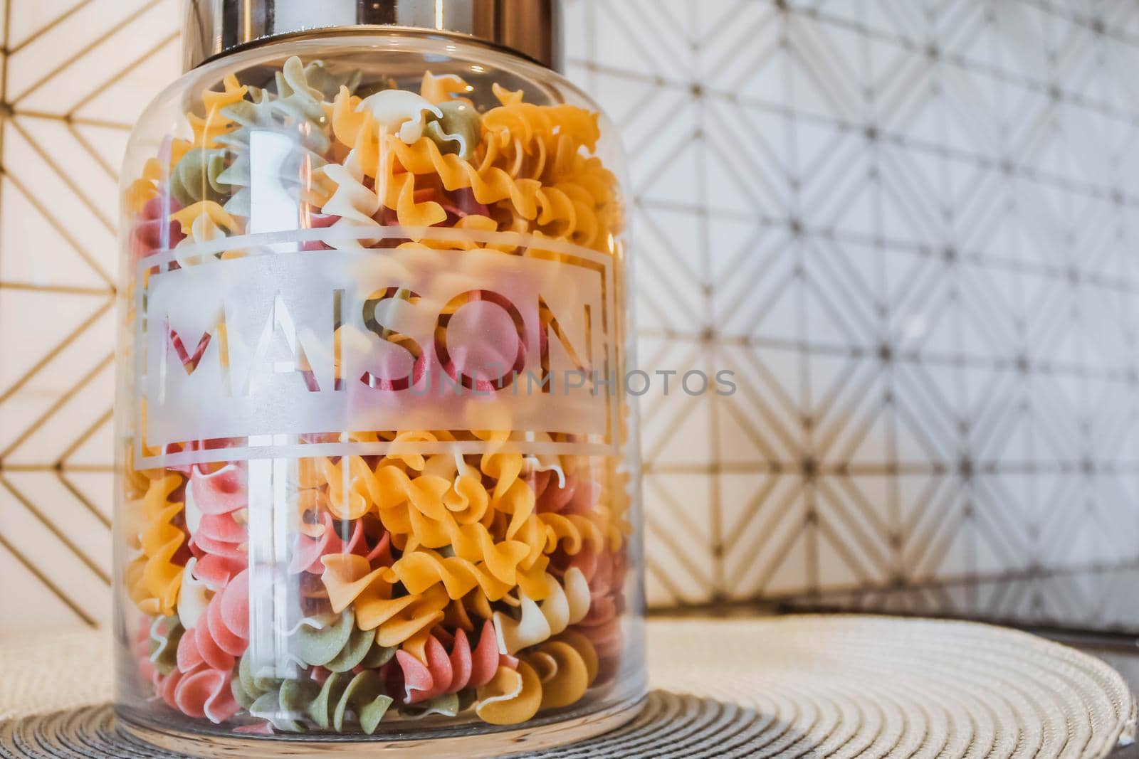 Variety of types and shapes of dry Italian pasta in a glass jar
