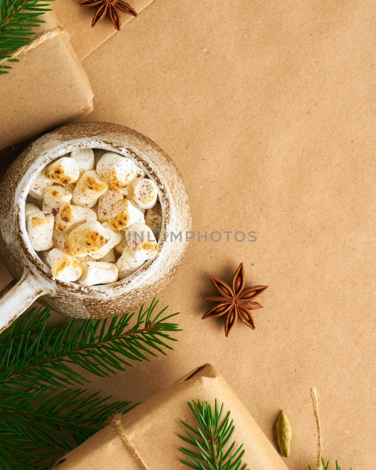 Christmas and Happy New Year zero waste craft paper background. Handmade gift Christmas box, fir branches, cup with hot chocolad, marshmallows, top view, copy space. Ecofriendly plastic free concept by NataBene
