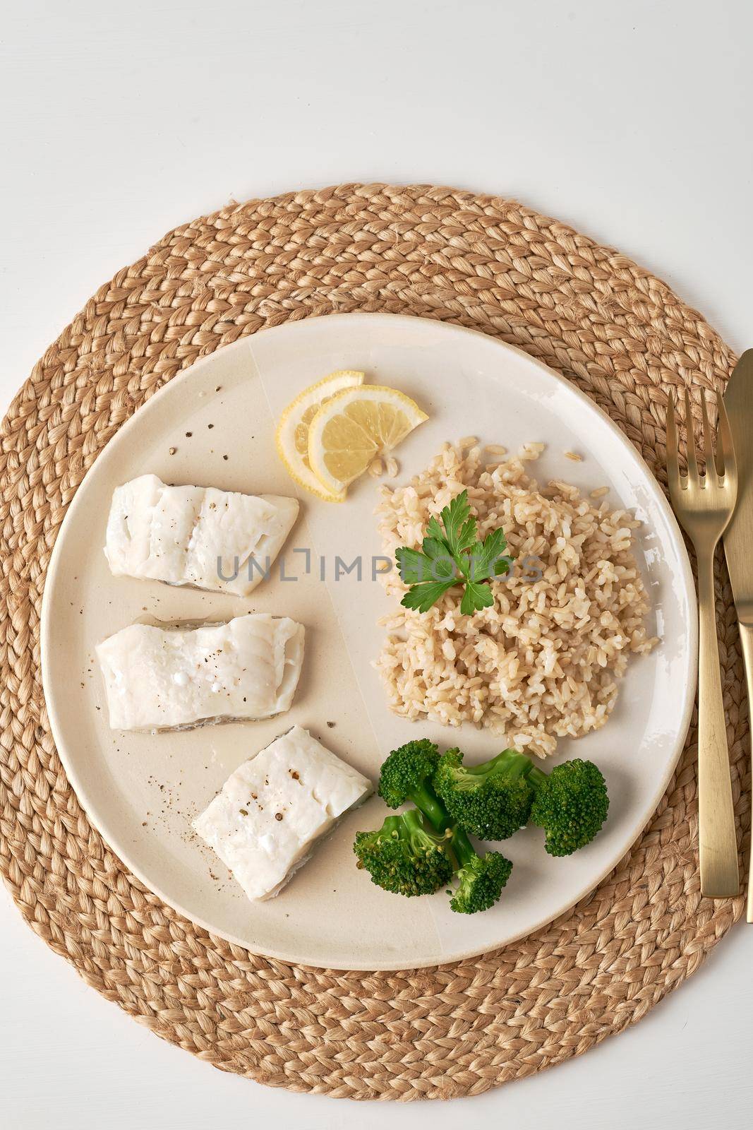 Steamed cod with brown rice and vegetables, dash fodmap diet top view by NataBene
