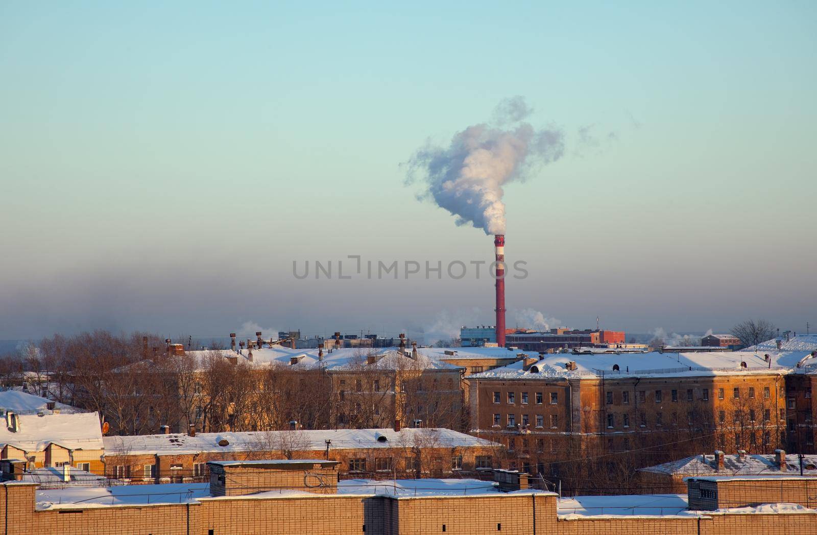 Roofs under snow and pipe with smoke by rivertime