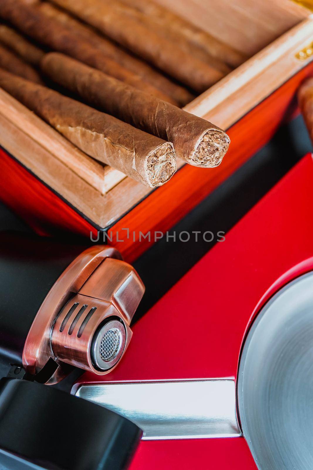 Open humidor with cigars, ashtray and cigar torch. Smoking set accessories. luxury lifestyle flat lay top view, vertical by JuliaDorian