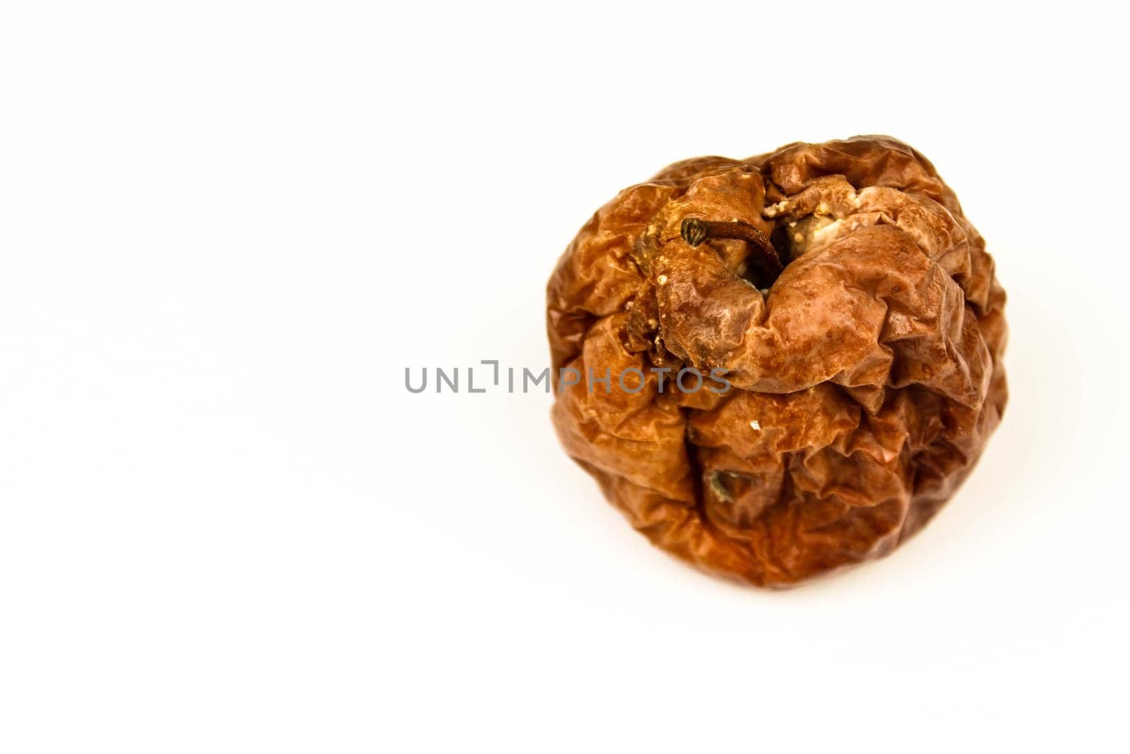 Old rotten apple with large DOF on white background by JuliaDorian