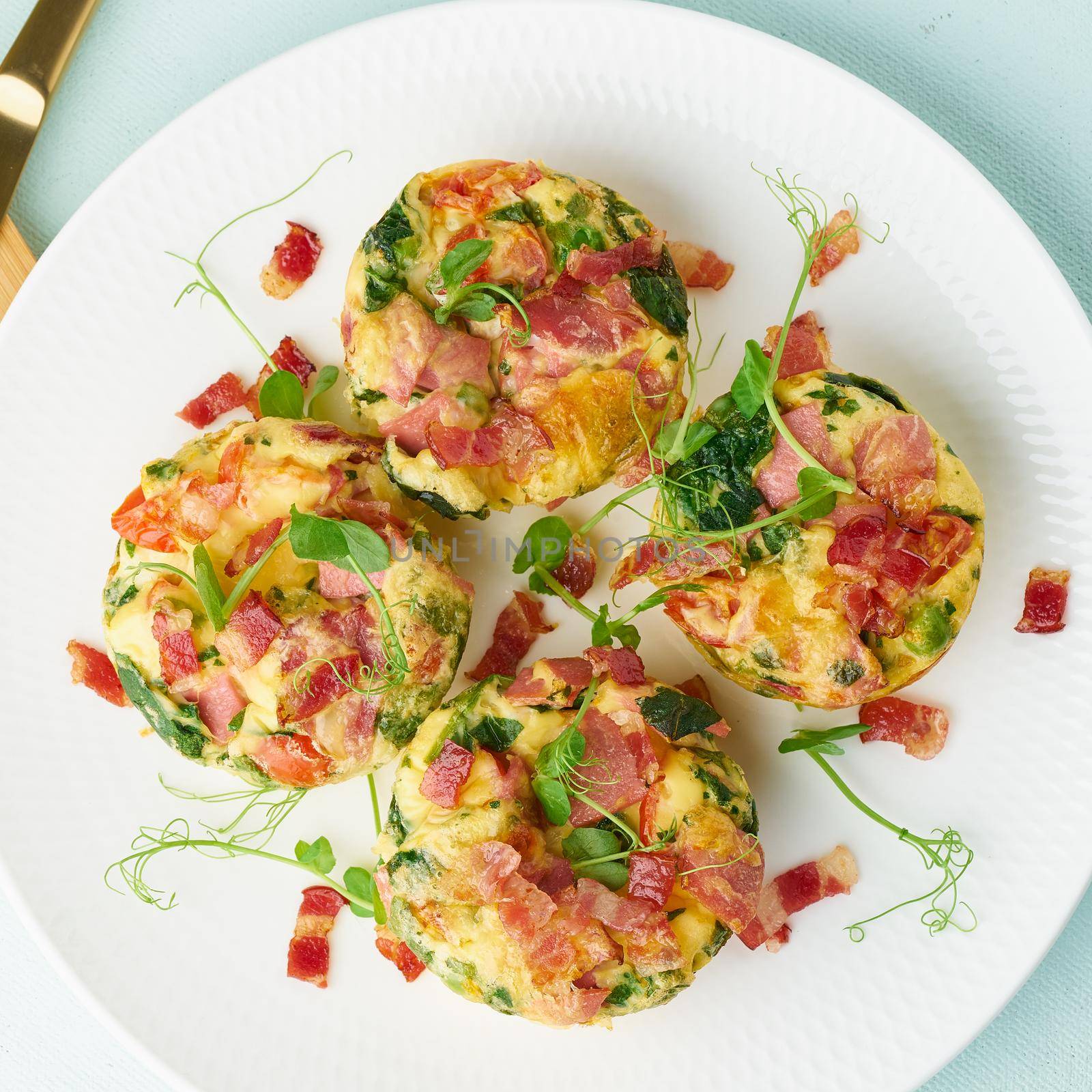 egg muffins with spinach and bacon, ketogenic keto diet low carb, pastel and modern background closeup