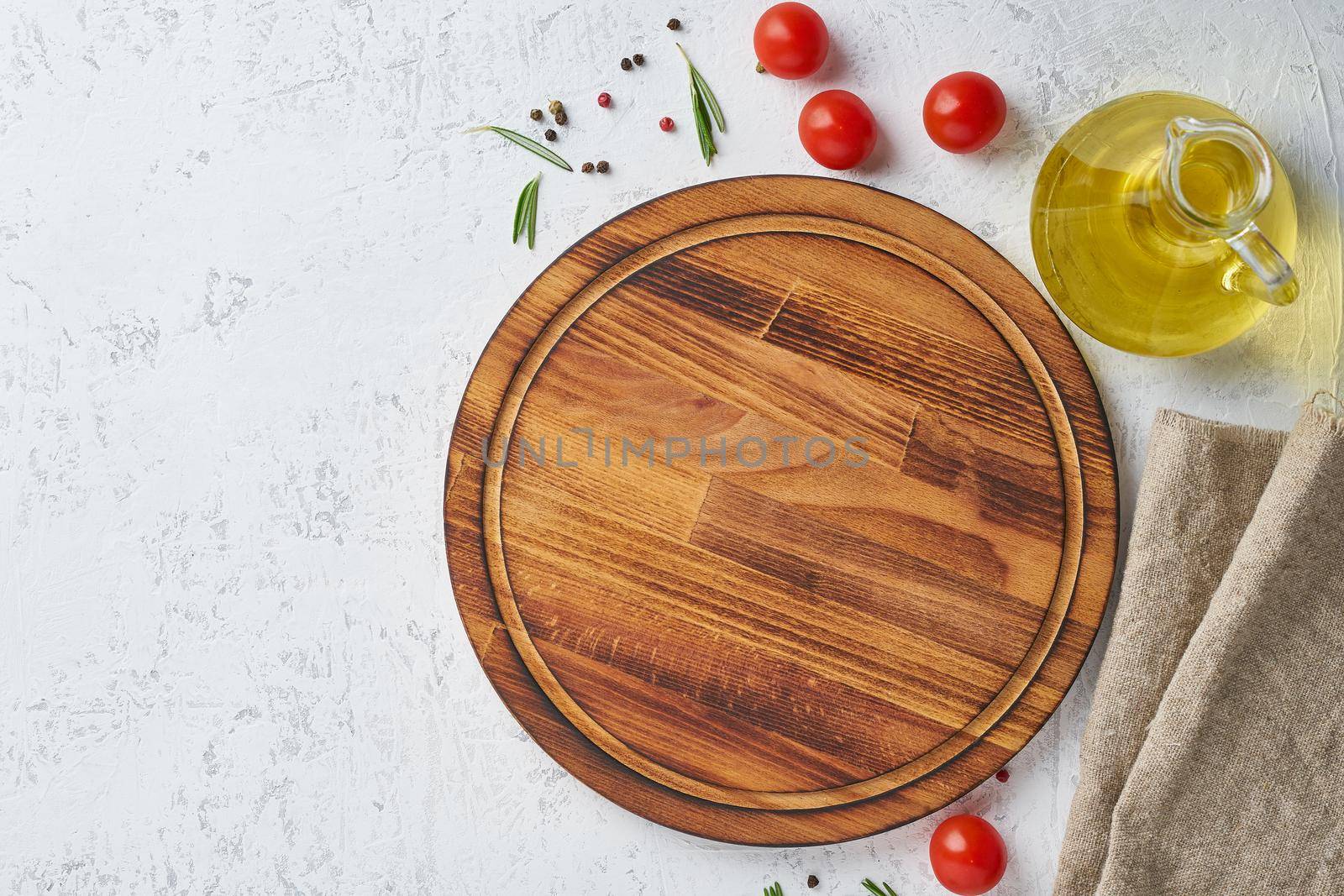 Spices, Herbs and a round wooden cutting board on white concrete backdrop. Top view, copy space. Menu, recipe, mock up, banner. Food seasoning background.