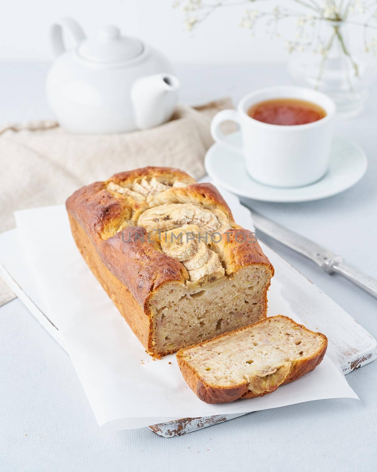 Banana bread, cake with banana, side view, vertical. The morning Breakfast with tea by NataBene