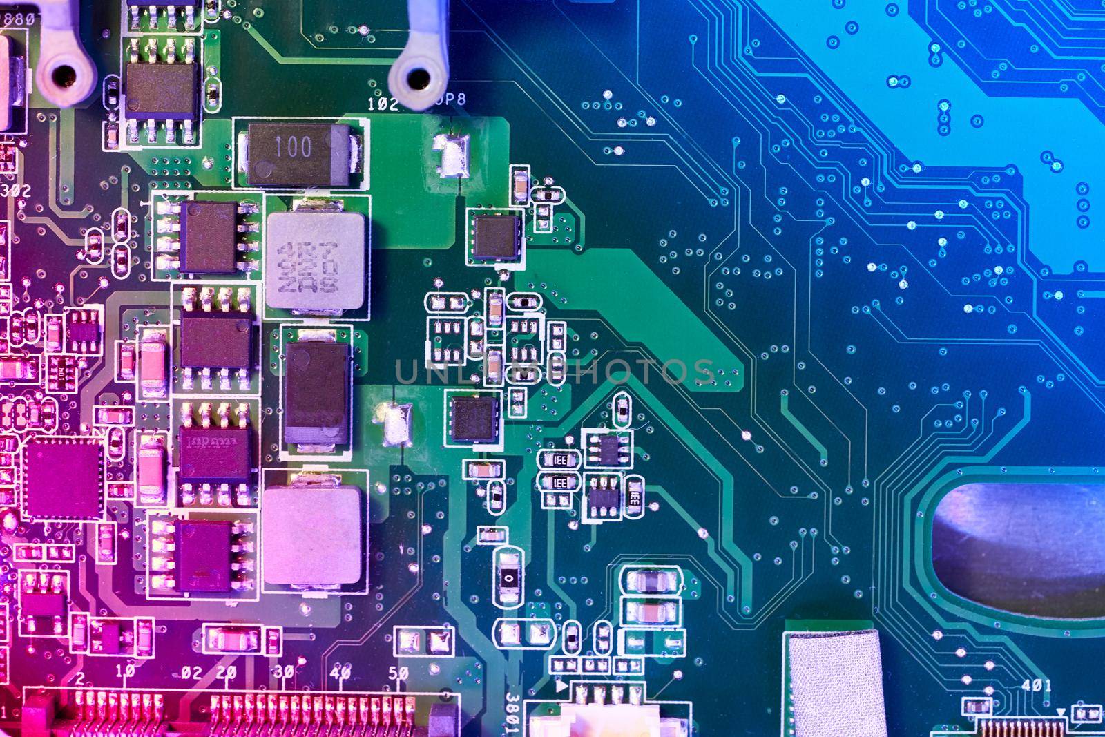 Computer motherboard background with blur neon multicolor glow