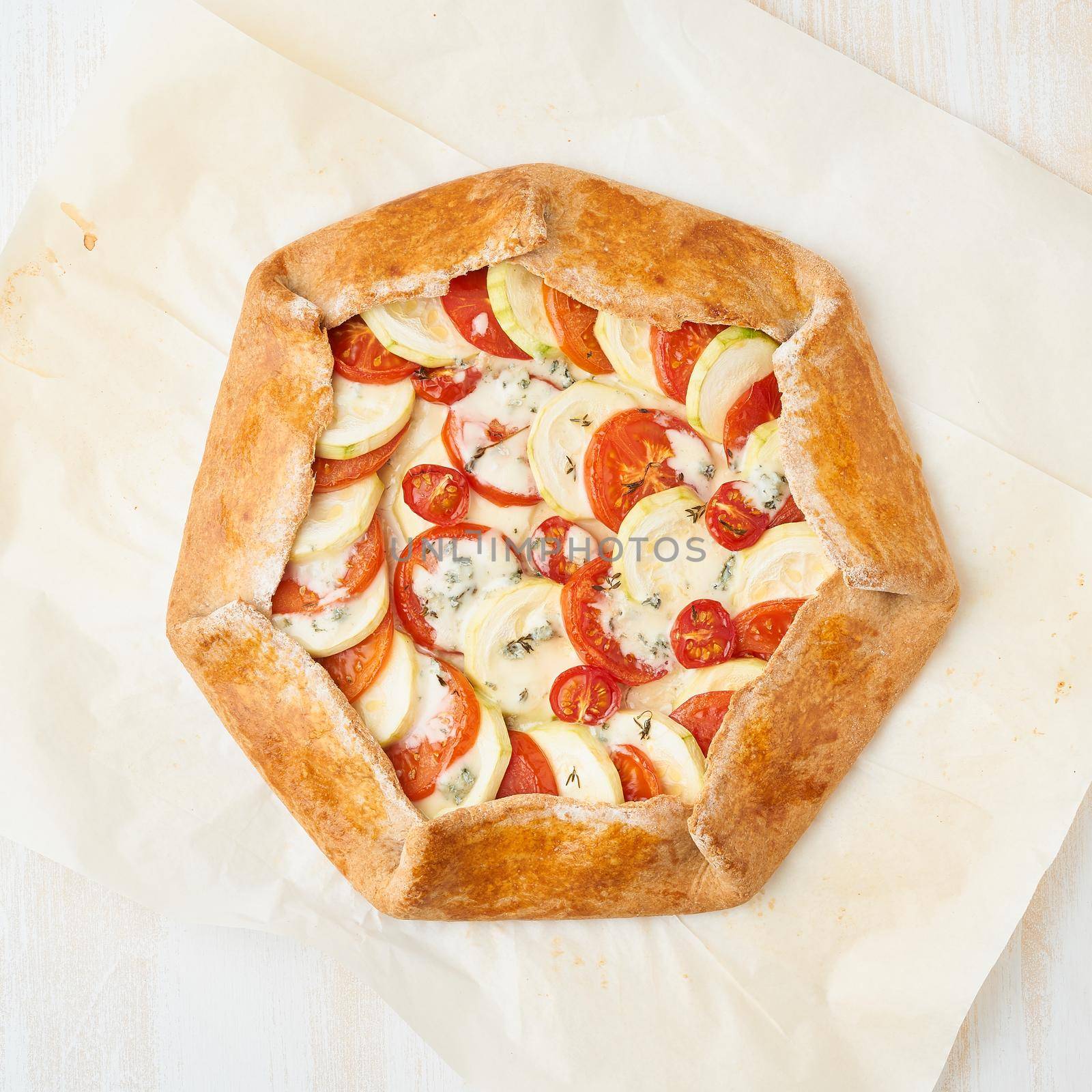 Step by step recipe. Homemade galette with vegetables, wholegrain pie. Top view, white wooden table