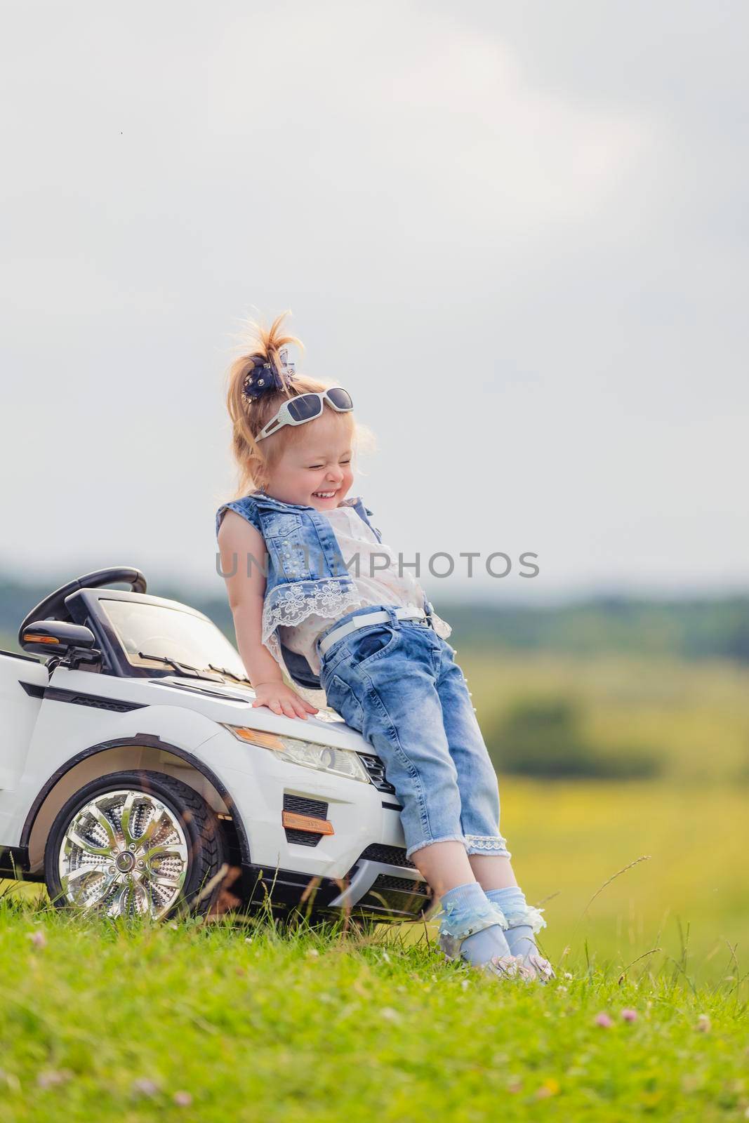 girl in sunglasses stands near the car by zokov