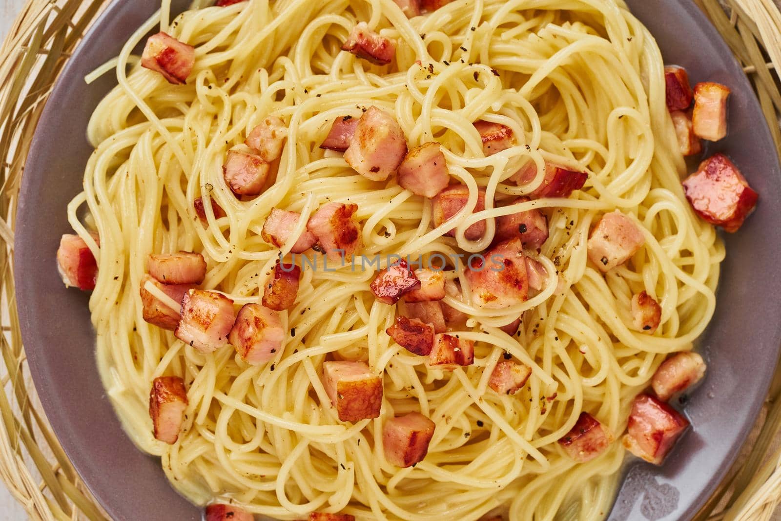 Close up carbonara pasta. Spaghetti with bacon, egg, parmesan cheese and cream sauce. Top view. Traditional italian cuisine.