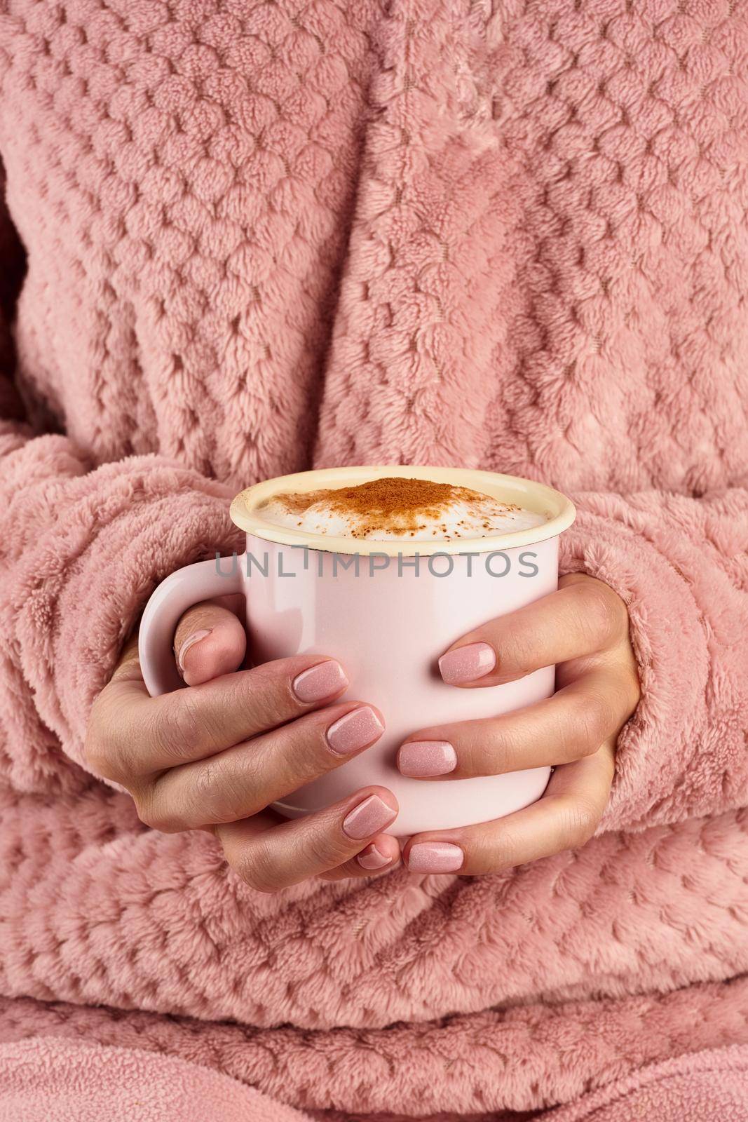 morning hot chocolate on a cold autumn morning, hands holding a mug with a drink, cozy atmosphere, vertical