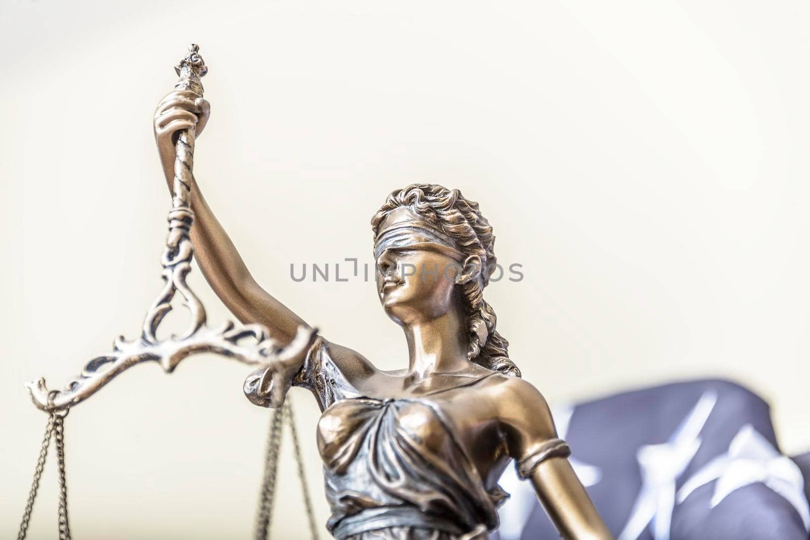 The statue of justice Themis or Iustitia, the goddess of justice blindfolded against a flag of the United States of America, as a legal concept