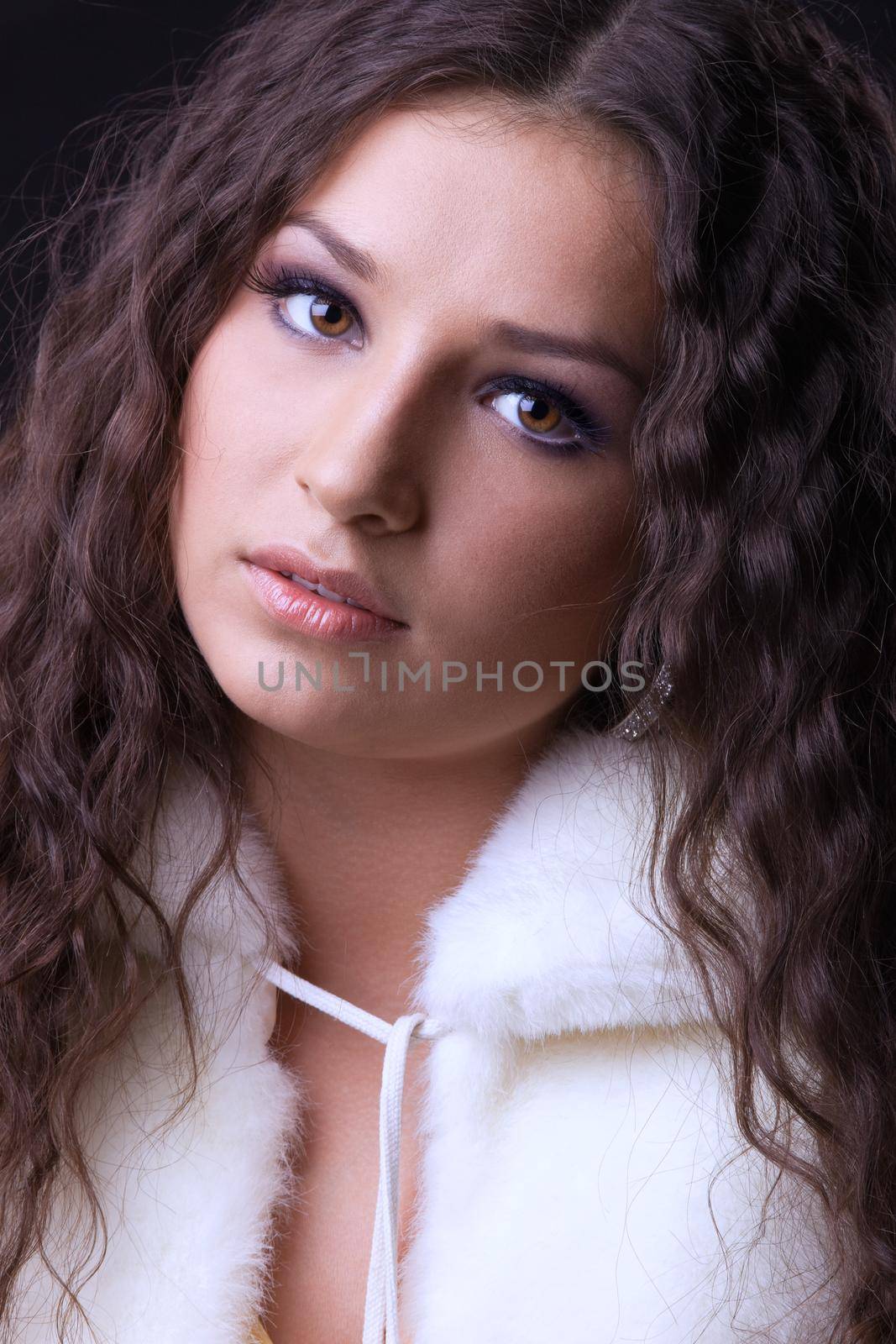 Young beauty girl close-up portrait in white fur coat
