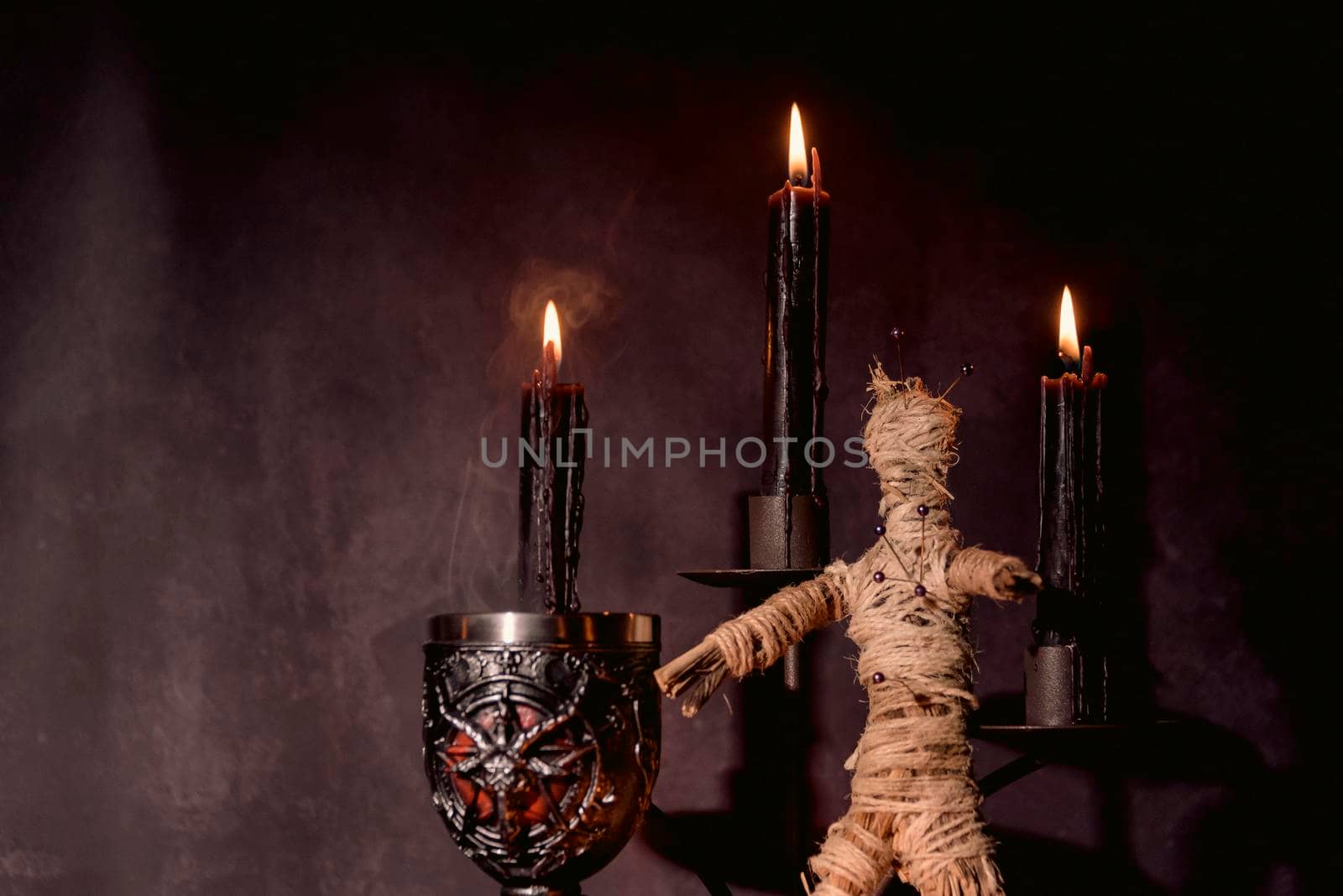 Voodoo Doll on a wooden background with dramatic lighting